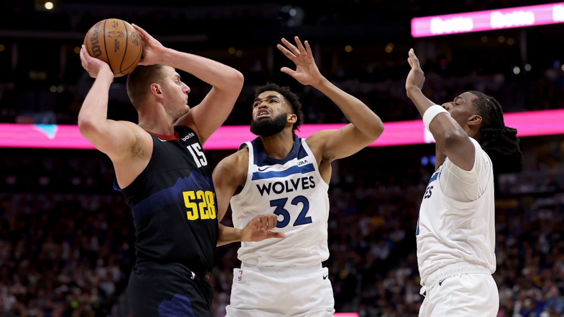 Nikola Jokic #15 of the Denver Nuggets attempts to pass over Karl-Anthony Towns #32 and Naz Reid #11 of the Minnesota Timberwolves during the first quarter in Game Two of the Western Conference Second Round Playoffs at Ball Arena on May 06, 2024 in Denver, Colorado.