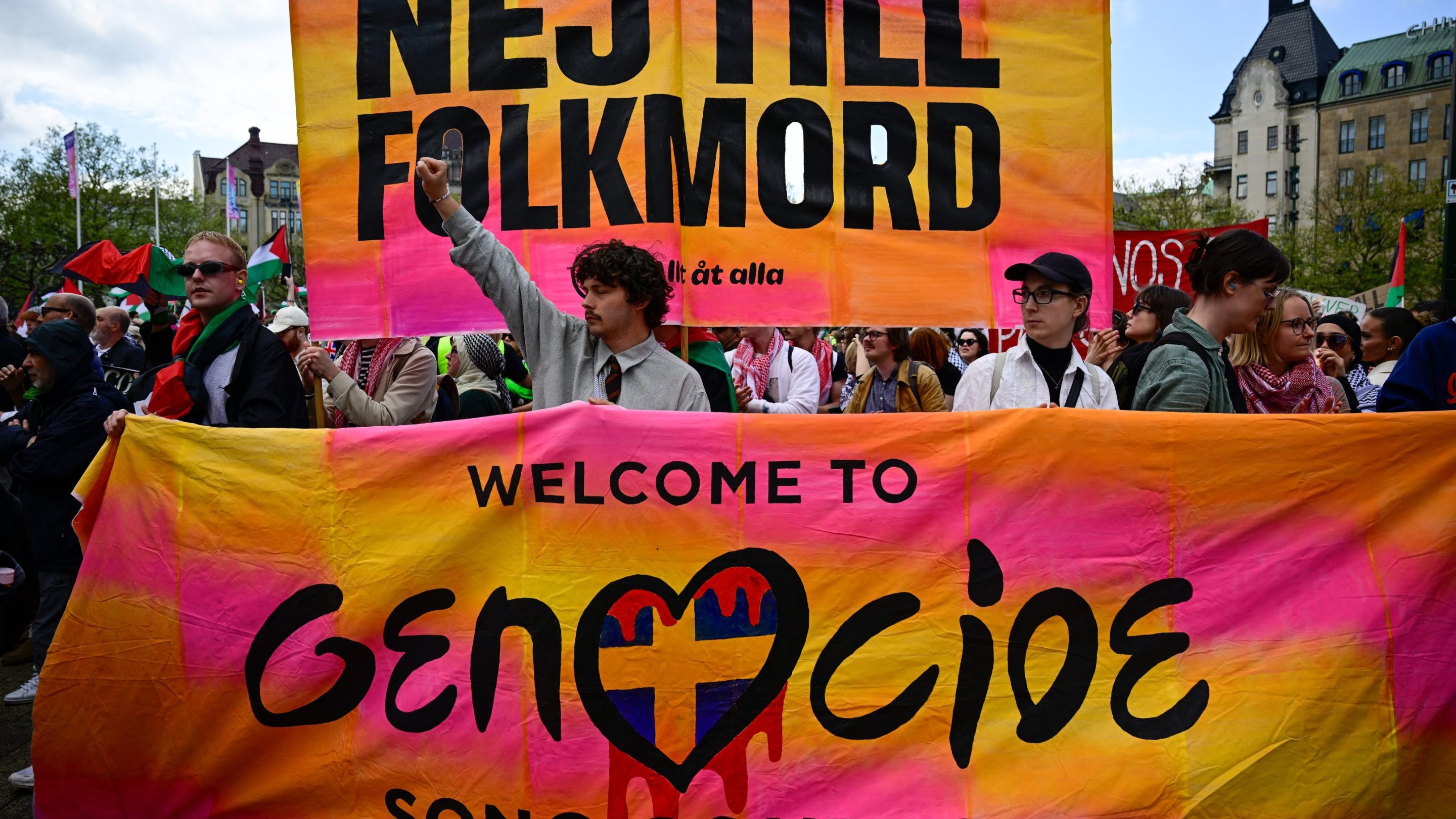 Pro-Palestinian protesters opposing Israel's participation in the 68th edition of the Eurovision Song Contest (ESC) demonstrate in Malmo, Sweden, on May 11, 2024, with a poster saying : NEJ TILL FOLKMORD, Welcome to the Genocide Song Contest