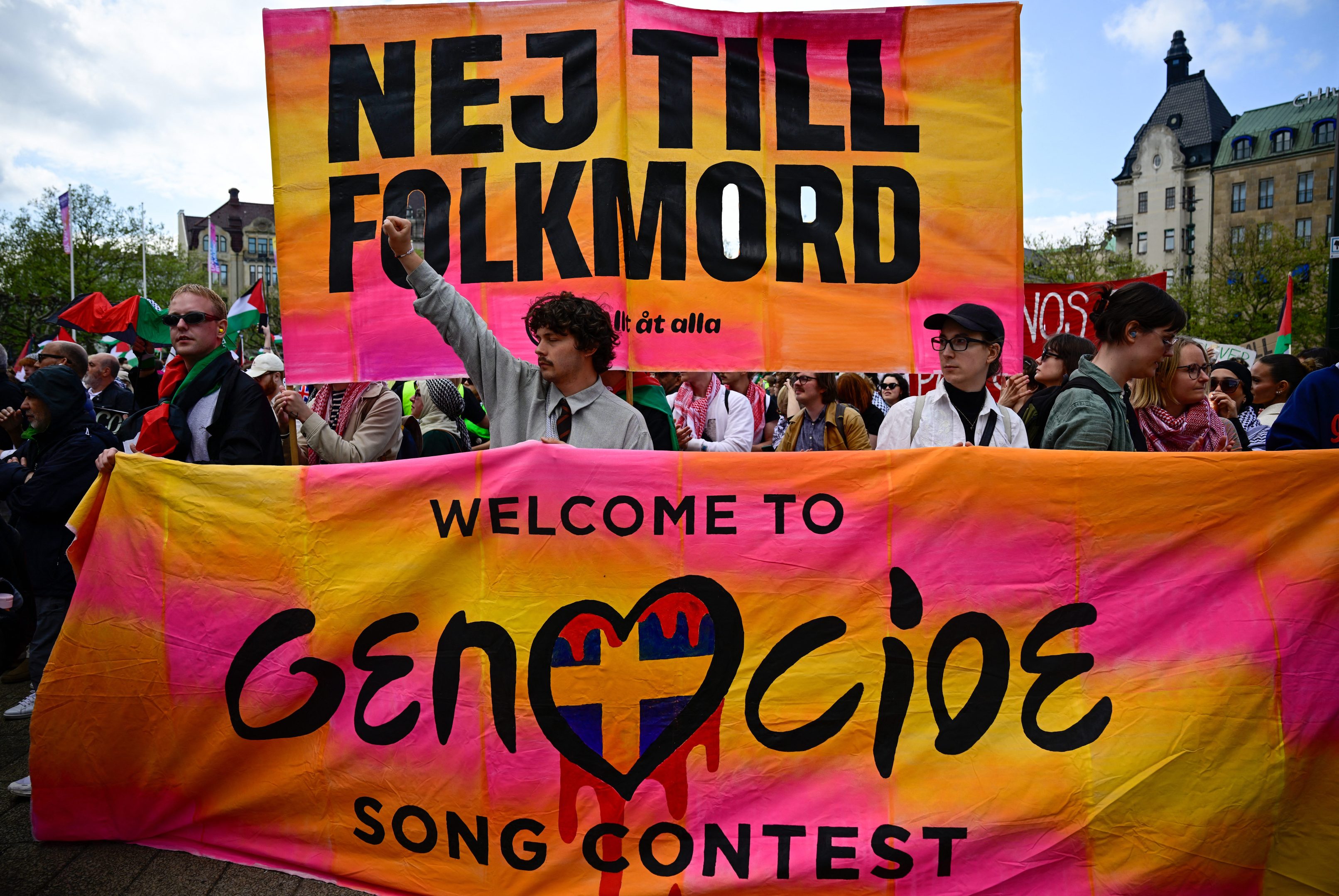 Pro-Palestinian protesters opposing Israel's participation in the 68th edition of the Eurovision Song Contest (ESC) demonstrate in Malmo, Sweden, on May 11, 2024, with a poster saying : NEJ TILL FOLKMORD, Welcome to the Genocide Song Contest