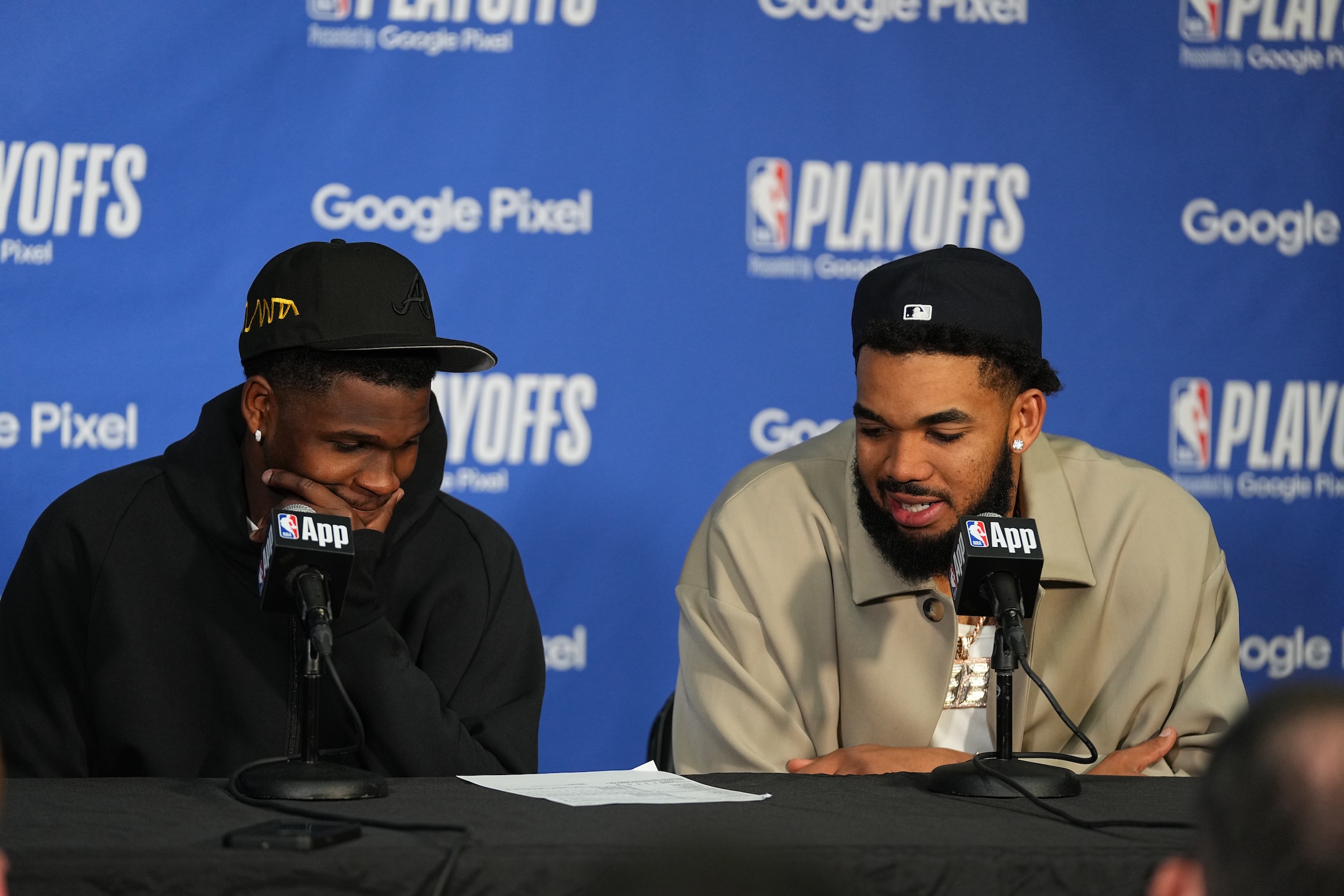 Anthony Edwards and Karl-Anthony Towns sit at the post-game press conference.