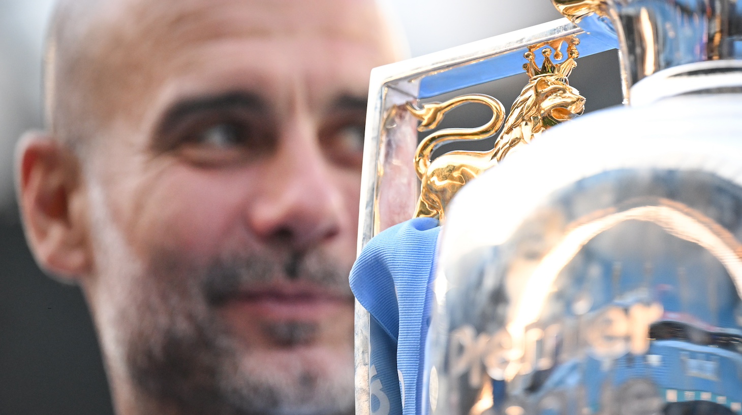 Pep Guardiola, Manager of Manchester City, poses for a photo with the Premier League title trophy following the team's victory in the Premier League match between Manchester City and West Ham United at Etihad Stadium on May 19, 2024 in Manchester, England.
