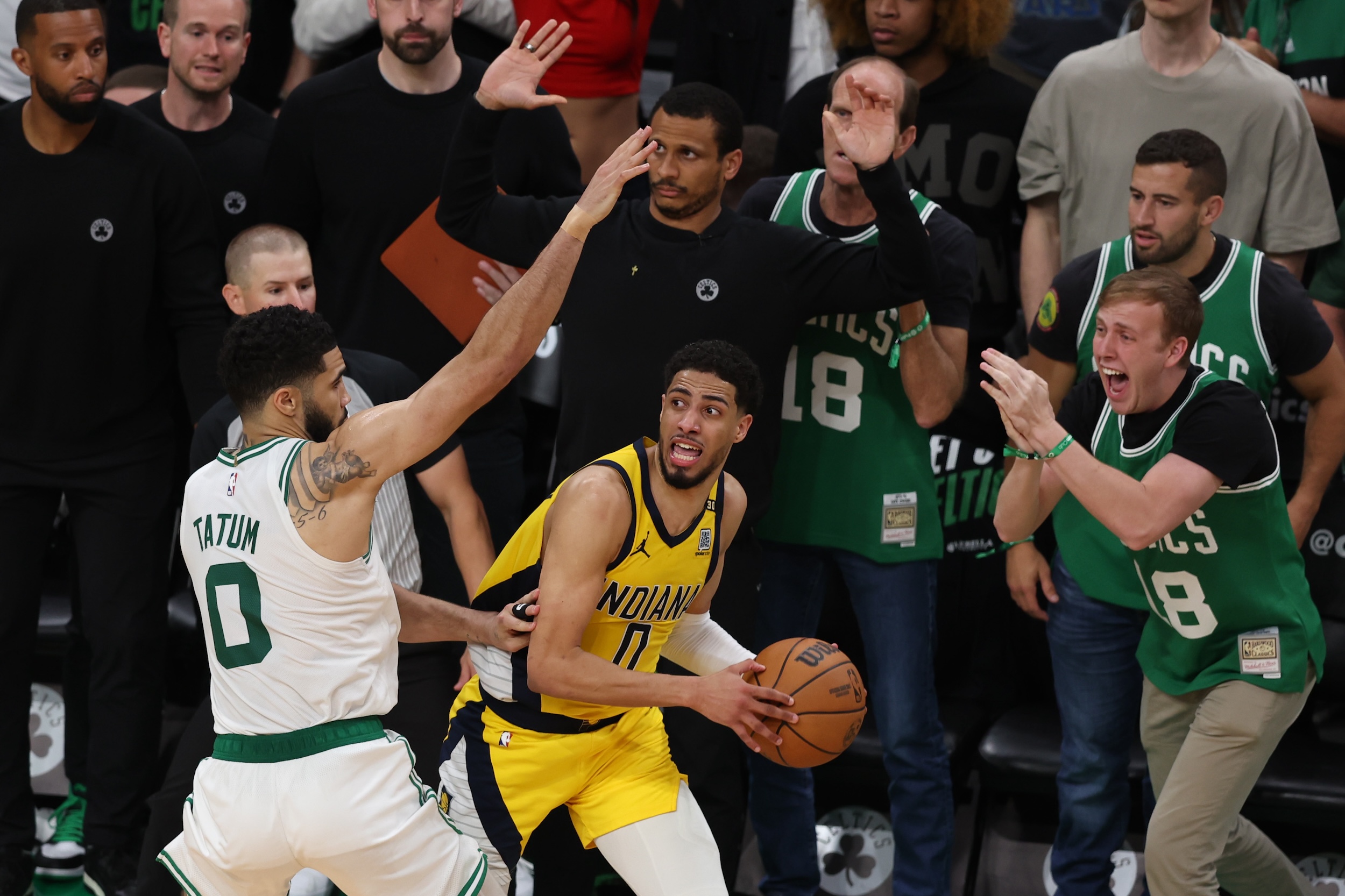 Tyrese Haliburton is hounded on the sideline by Jayson Tatum.