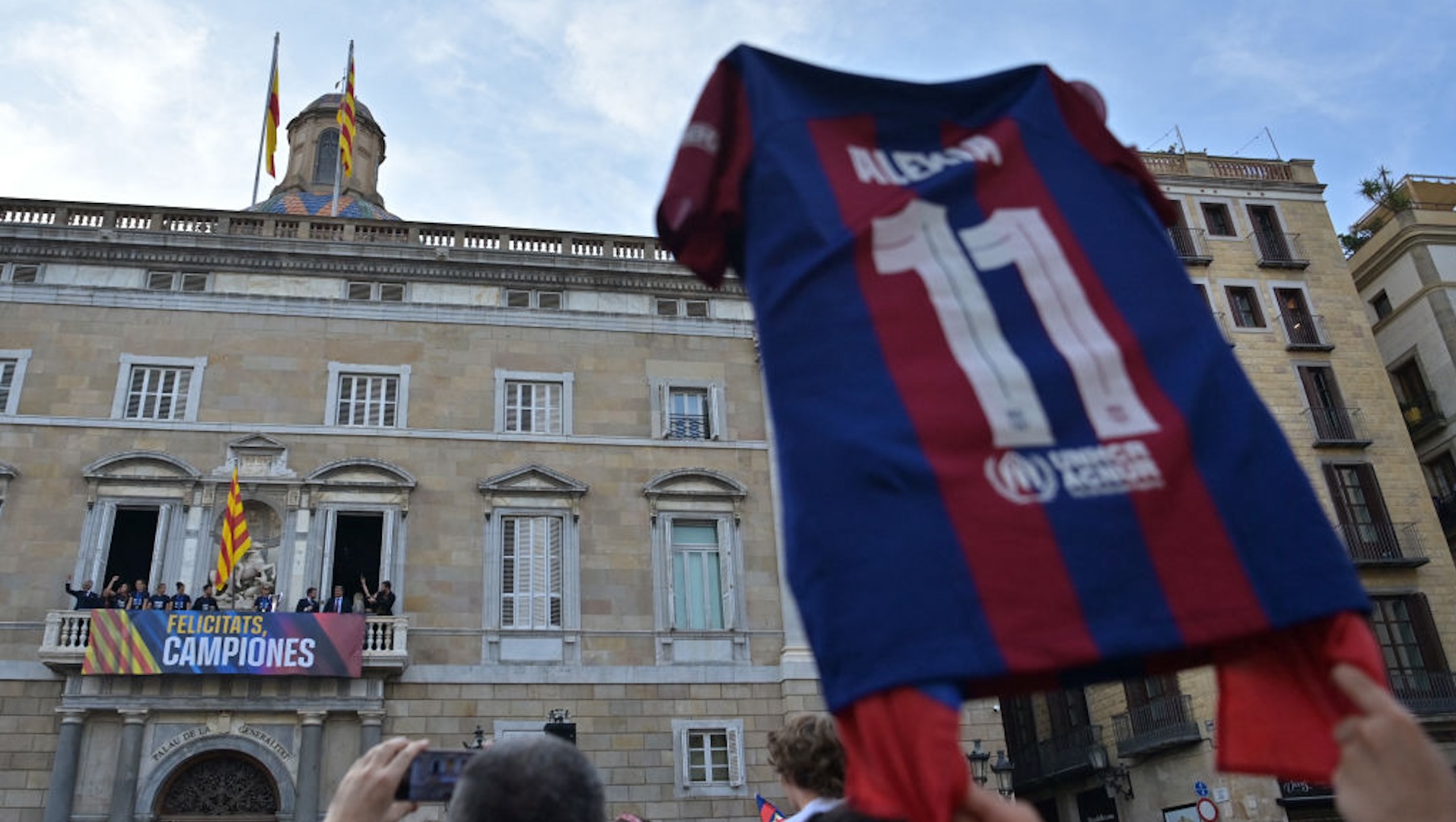 FC Barcelona women's football team present their Champions League trophy to supporters from the balcony of the Catalan Regional Government headquarters one day after getting their third Champions League triumph, in Barcelona on May 26, 2024. The Catalans finally avenged final defeats by Lyon in 2019 and 2022 yesterday in Bilbao, beating the French giants 2-0 to lift the Champions League for the third time.
