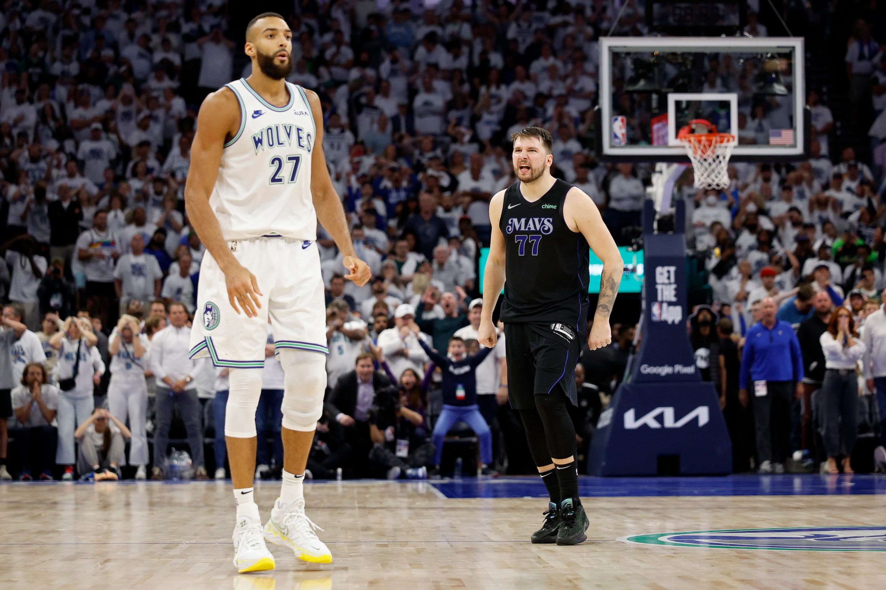 Luka Doncic exults/leers in the direction of Minnesota center Rudy Gobert after hitting the game three-pointer over him in Game 2 of the Western Conference Finals. Luka's really wet-looking.