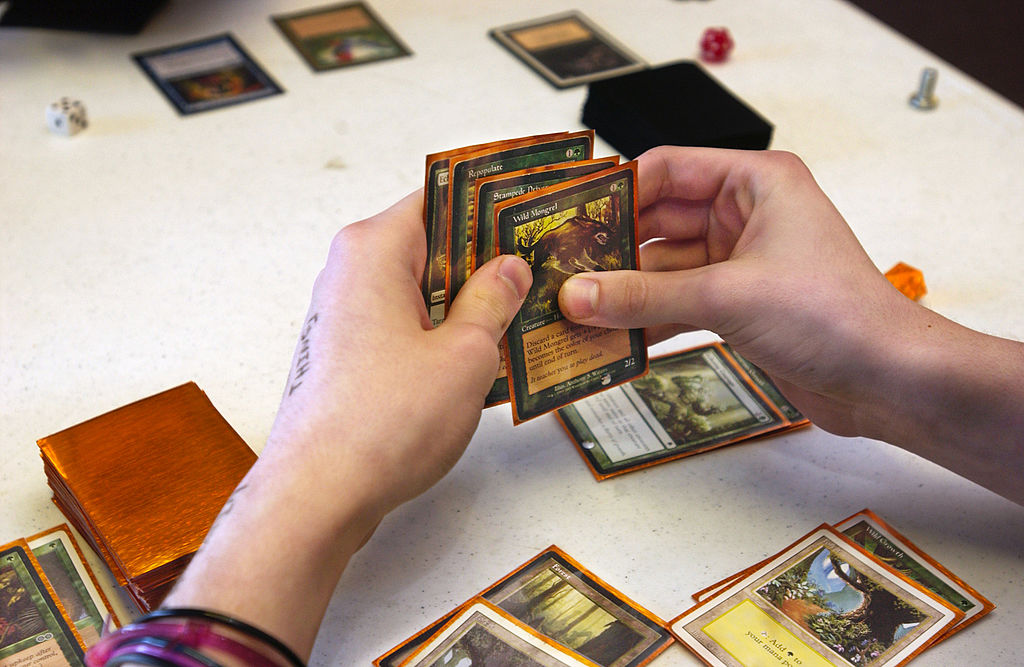 A player holds a hand of Magic cards during a game