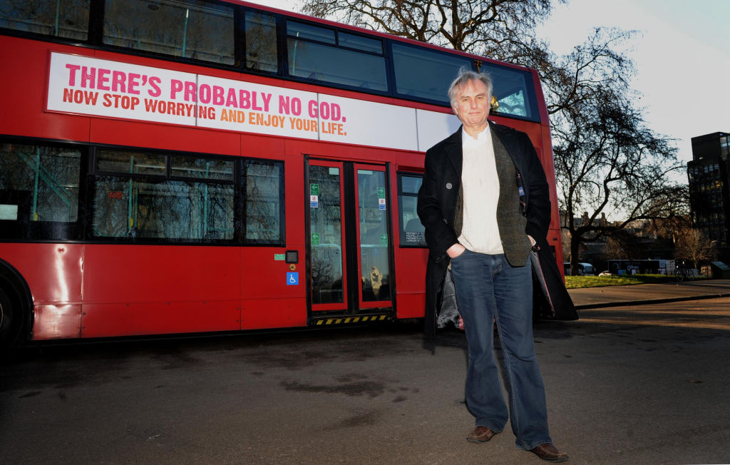 Professor Richard Dawkins next to a bus displaying an atheist message in Kensington Gardens, London.