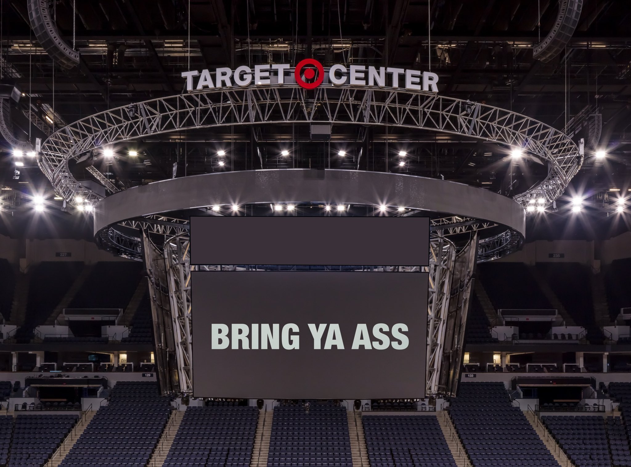A photo of the scoreboard screen at the Target Center in Minneapolis displaying the words "Bring Ya Ass"
