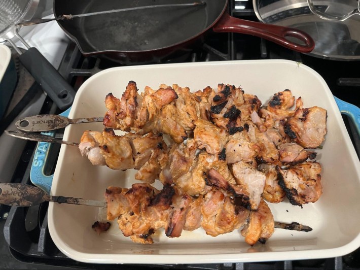 Skewers of grilled boneless, skinless chicken thigh, looking delicious.