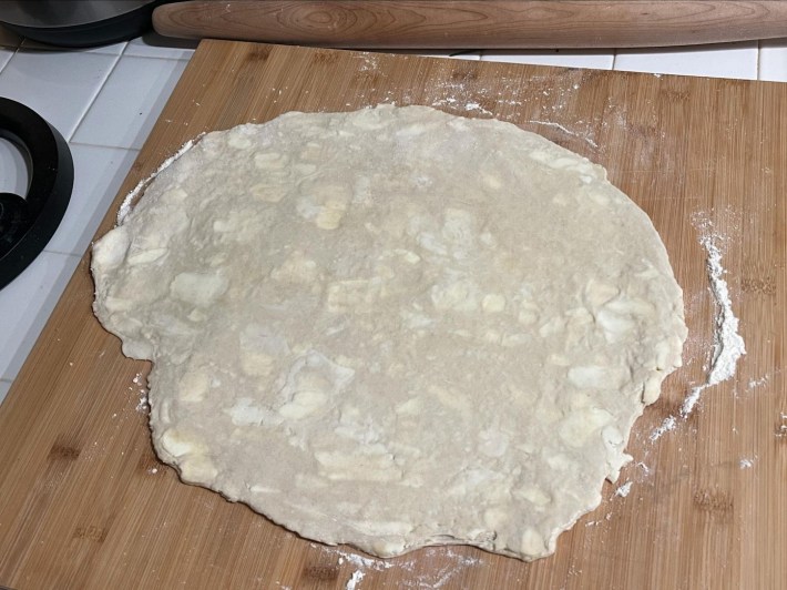 Rolled-out pastry dough, with what really are some absolute units of butter studded here and there throughout it.