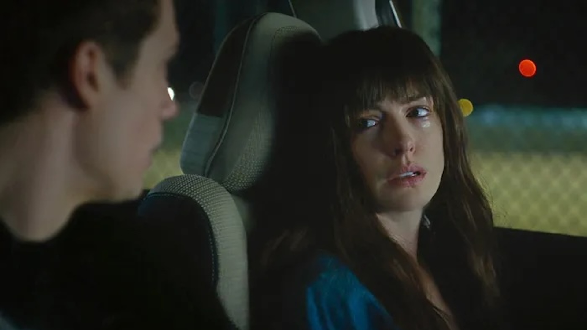 Anne Hatahway cries in her Subaru in a scene from The Idea of You