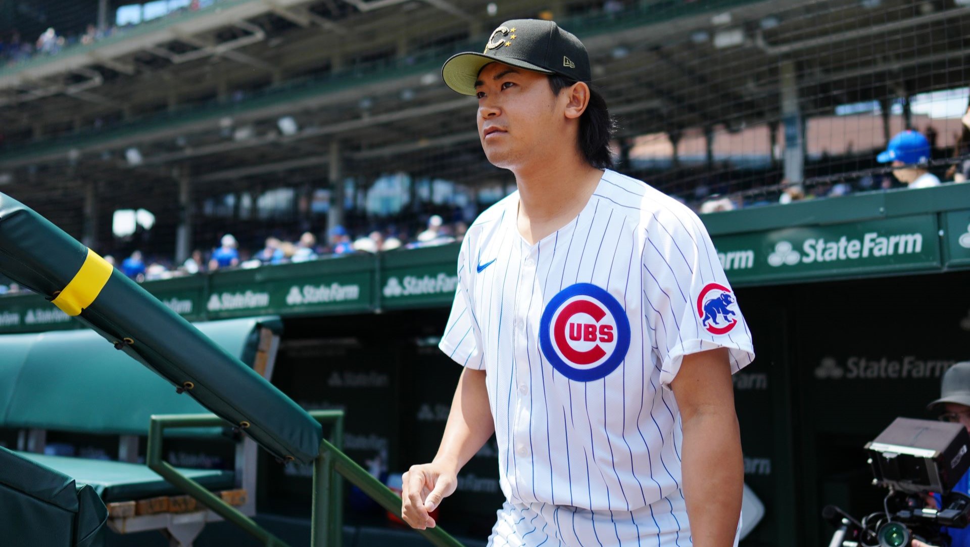 Shota Imanaga #18 of the Chicago Cubs looks on from the dugout prior to the game between the Pittsburgh Pirates and the Chicago Cubs.
