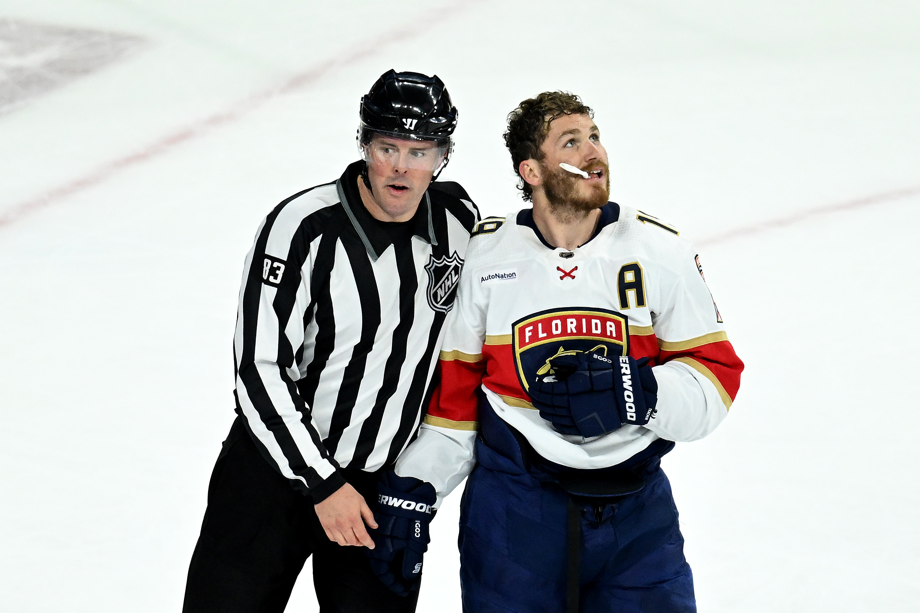 RALEIGH, NORTH CAROLINA - MAY 20: Matthew Tkachuk #19 of the Florida Panthers looks on after a fight against the Carolina Hurricanes during the second period in Game Two of the Eastern Conference Final of the 2023 Stanley Cup Playoffs at PNC Arena on May 20, 2023 in Raleigh, North Carolina. He's kind of holding hands with the ref that's carting him away