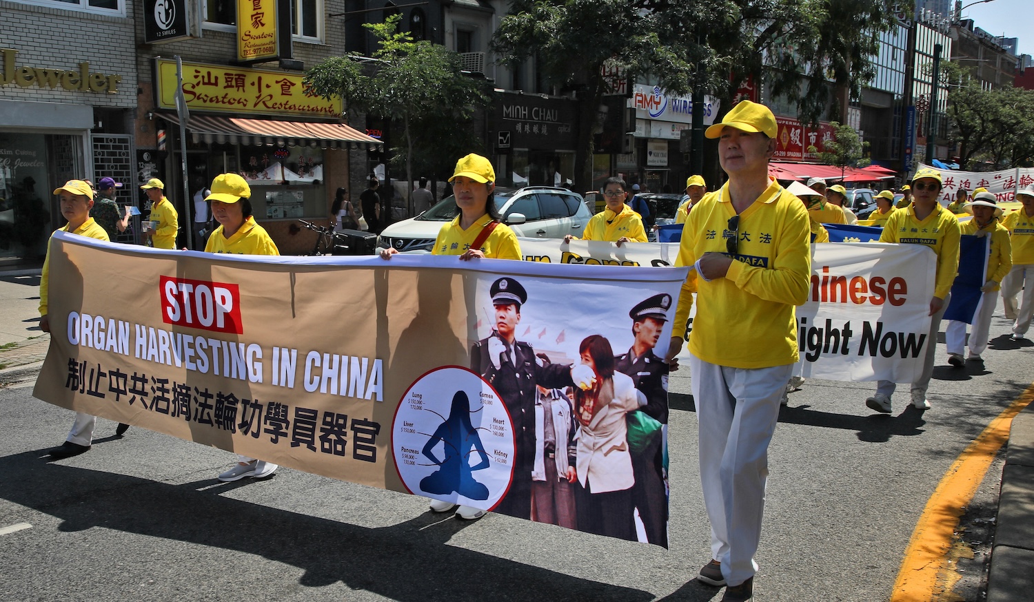 Members of the Falun Gong (Falun Dafa) held a parade through Chinatown to protest against the Communist Party of China in Toronto, Ontario, Canada, on August 19, 2023. The Communist Party of China has allegedly tried to wipe out Falun Gong with torture and violence because of their beliefs. Falun Gong is a traditional Chinese spiritual discipline that brings together meditation, energy exercises and moral teachings as a means to cultivating the mind and body towards enlightenment. (Photo by Creative Touch Imaging Ltd./NurPhoto)