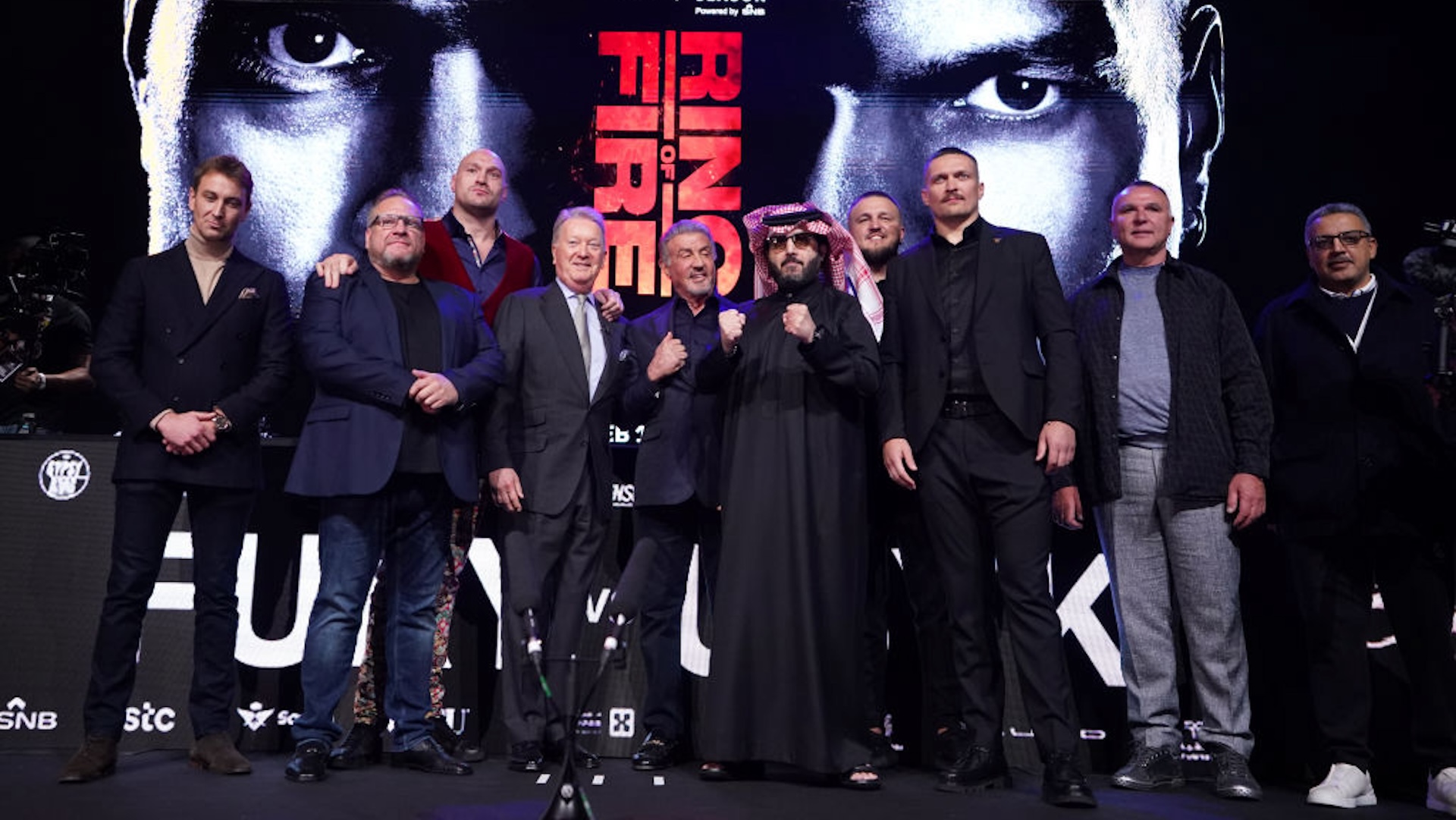 Tyson Fury (third left) and Oleksandr Usyk (third right) pose alongside promoter Frank Warren (fourth left), actor Sylvester Stallone (centre) and The Saudi Chairman of General Authority for Entertainment Turki Alalshikh during a press conference at Outernet London.