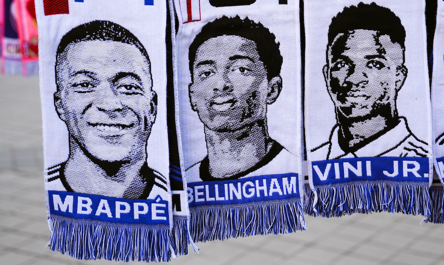 Scarves of Kylian Mbappe, Jude Bellingham and Vinicius Jr.hang in a souvenir stall outside the stadium prior to the UEFA Champions League 2023/24 round of 16 second leg match between Real Madrid CF and RB Leipzig at Estadio Santiago Bernabeu on March 06, 2024 in Madrid, Spain.