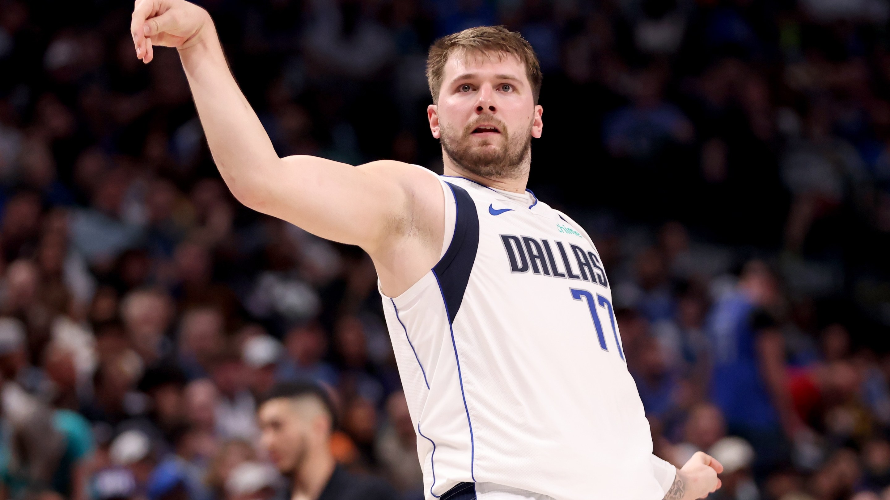 Luka Doncic does kind of a weird follow-through as he watches a shot against the Golden State Warriors in the first half at American Airlines Center on March 13, 2024 in Dallas, Texas.