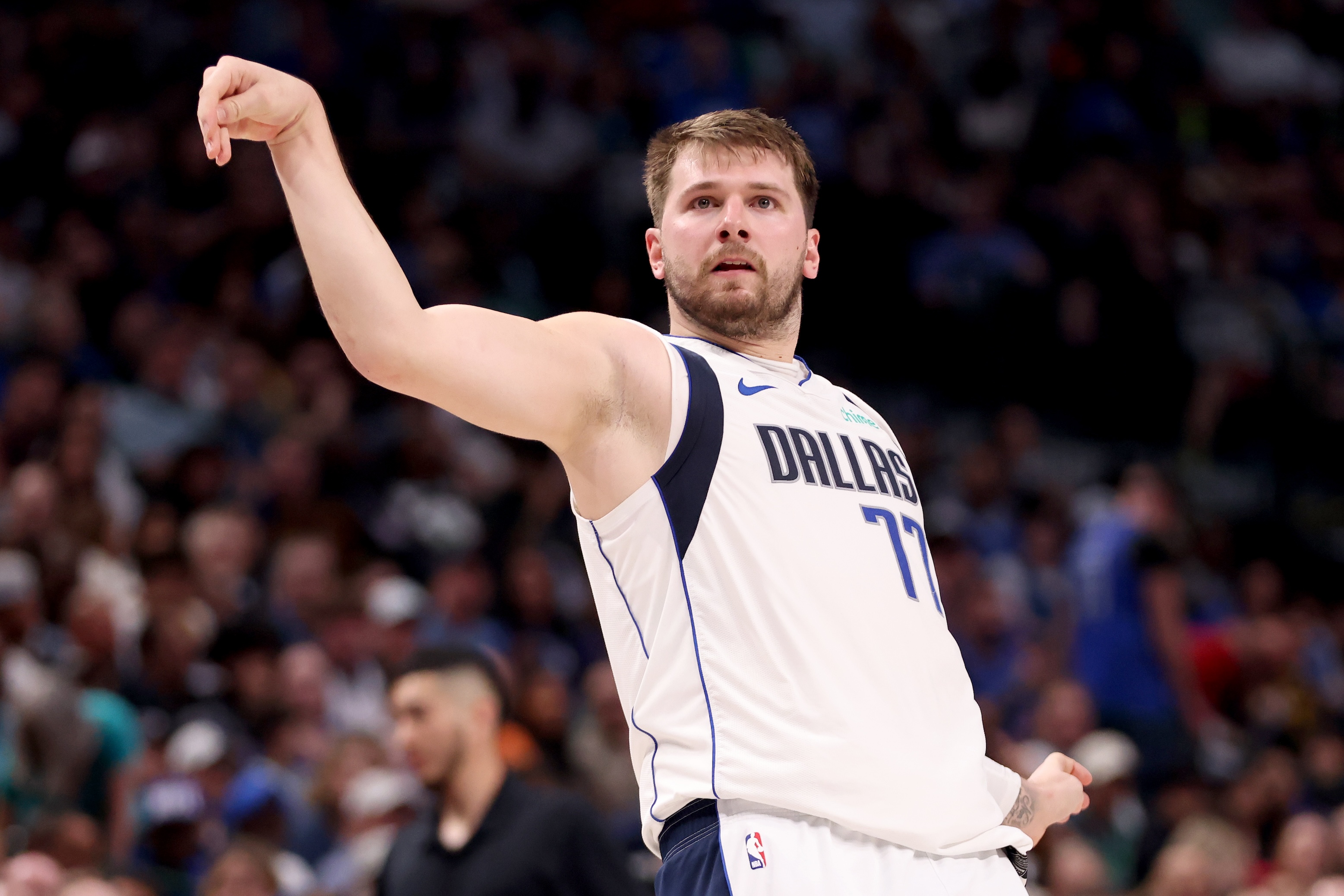 Luka Doncic does kind of a weird follow-through as he watches a shot against the Golden State Warriors in the first half at American Airlines Center on March 13, 2024 in Dallas, Texas.