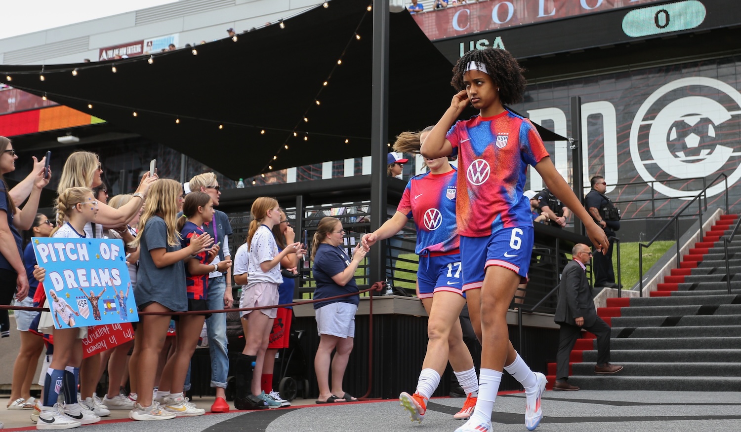 COMMERCE CITY, COLORADO - JUNE 01: Sam Coffey #17 and Lily Yohannes #6 of the United States enter the field for warmups prior to playing the Korea Republic at Dick's Sporting Goods Park on June 01, 2024 in Commerce City, Colorado. (Photo by Erin Chang/ISI Photos/USSF/Getty Images for USSF)