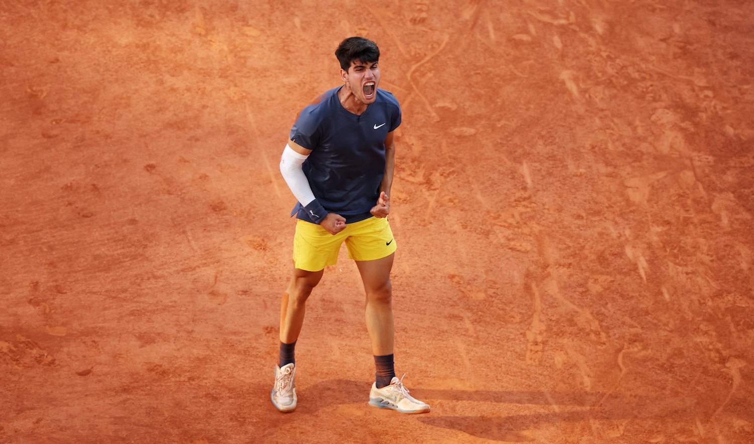 PARIS, FRANCE - JUNE 09: Carlos Alcaraz of Spain celebrates winning match point against Alexander Zverev of Germany during the Men's Singles Final match on Day 15 of the 2024 French Open at Roland Garros on June 09, 2024 in Paris, France. (Photo by Clive Brunskill/Getty Images)