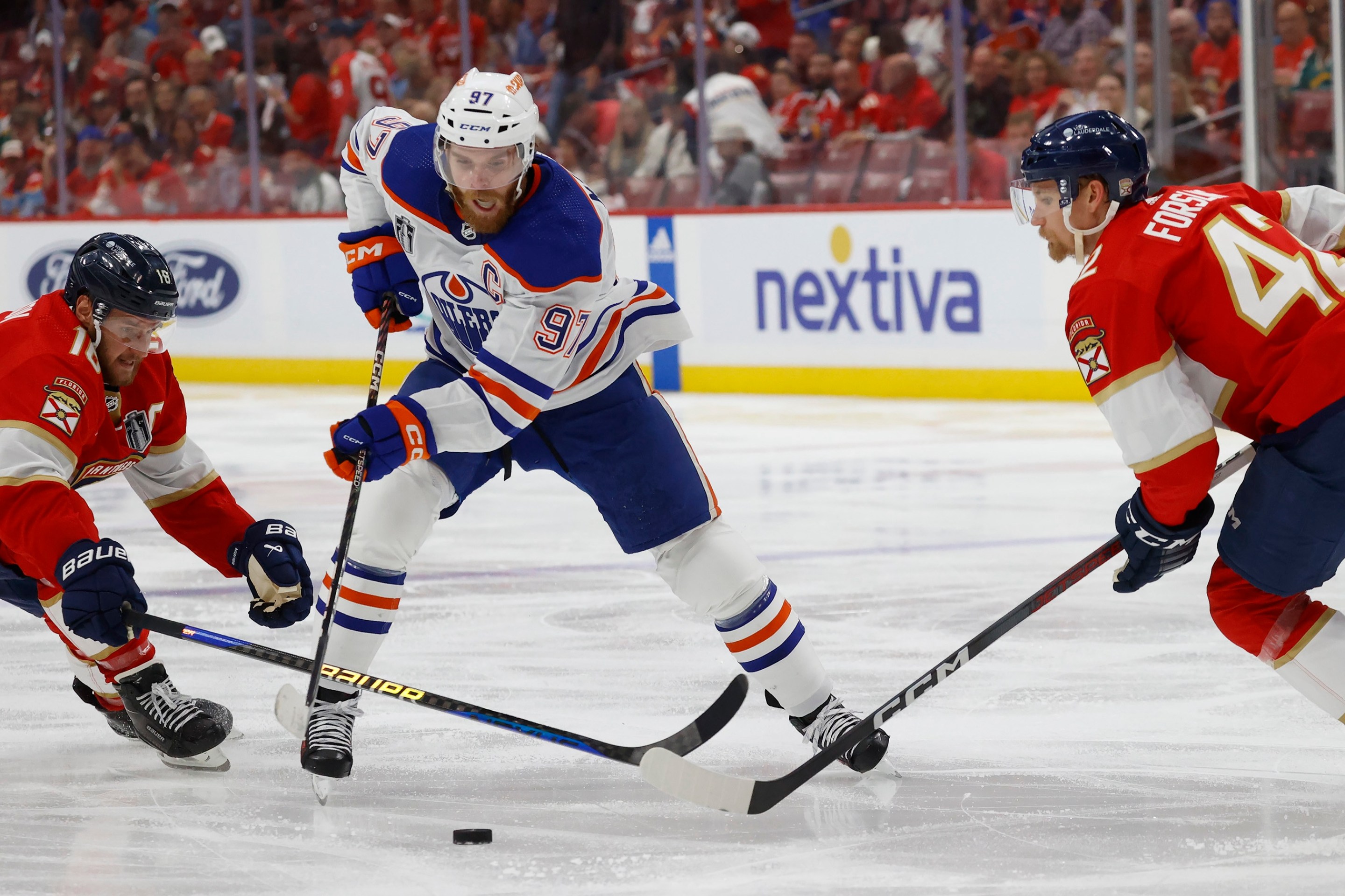 , FLORIDA - JUNE 18: Connor McDavid #97 of the Edmonton Oilers skates between teammates Aleksander Barkov #16 and Gustav Forsling #42 of the Florida Panthers in Game Five of the Stanley Cup Final at the Amerant Bank Arena on June 18, 2024 in Sunrise, Florida. (Photo by Eliot J. Schechter/NHLI via Getty Images)