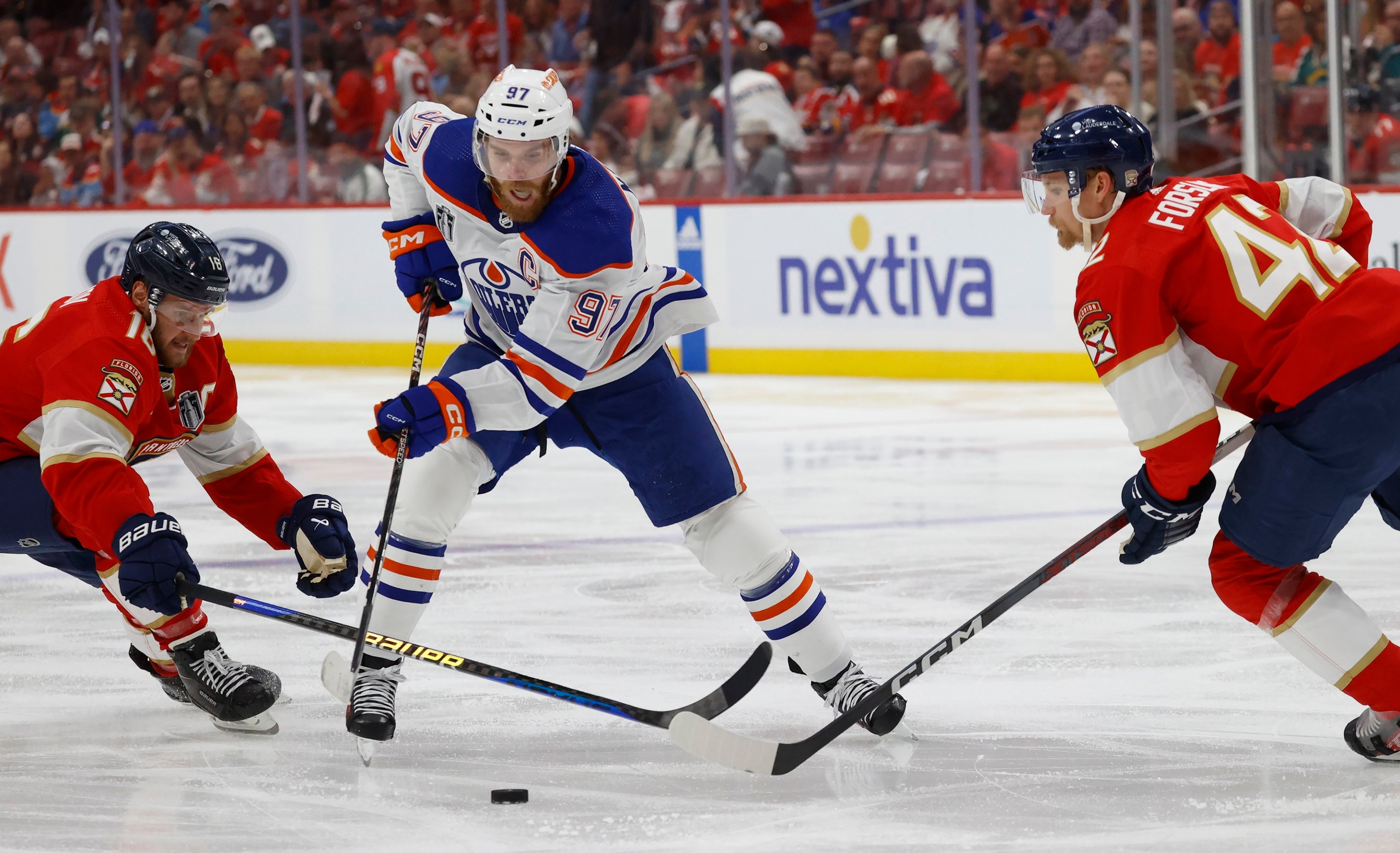 , FLORIDA - JUNE 18: Connor McDavid #97 of the Edmonton Oilers skates between teammates Aleksander Barkov #16 and Gustav Forsling #42 of the Florida Panthers in Game Five of the Stanley Cup Final at the Amerant Bank Arena on June 18, 2024 in Sunrise, Florida. (Photo by Eliot J. Schechter/NHLI via Getty Images)