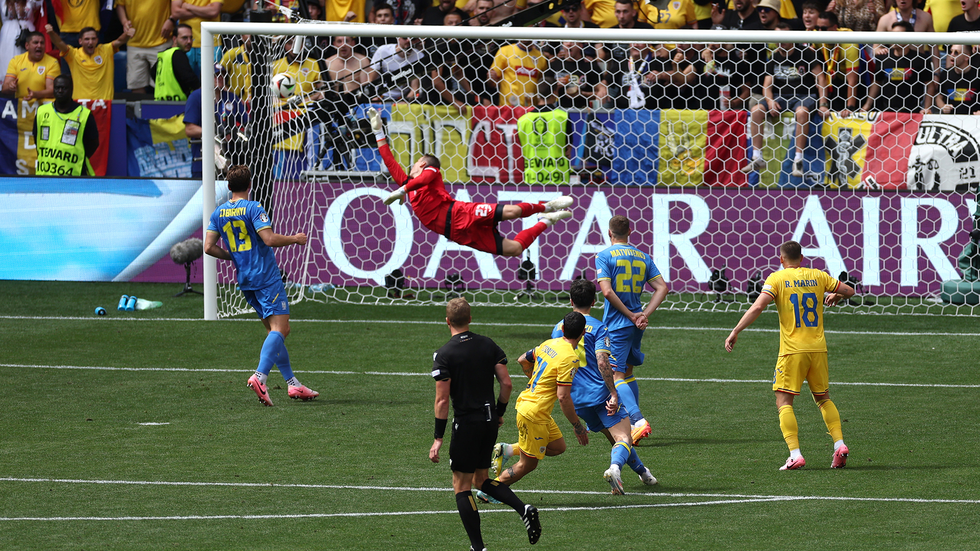 Nicolae Stanciu of Romania scores his team's first goal past Andriy Lunin of Ukraine during the UEFA EURO 2024 group stage match between Romania and Ukraine at Munich Football Arena on June 17, 2024 in Munich, Germany.