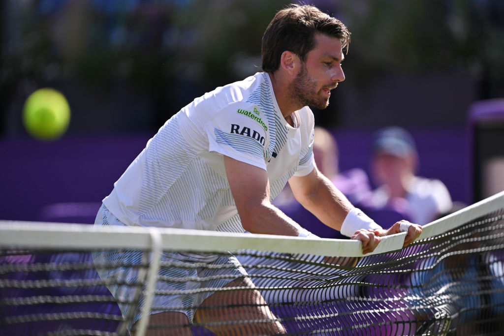 Cameron Norrie runs into the net