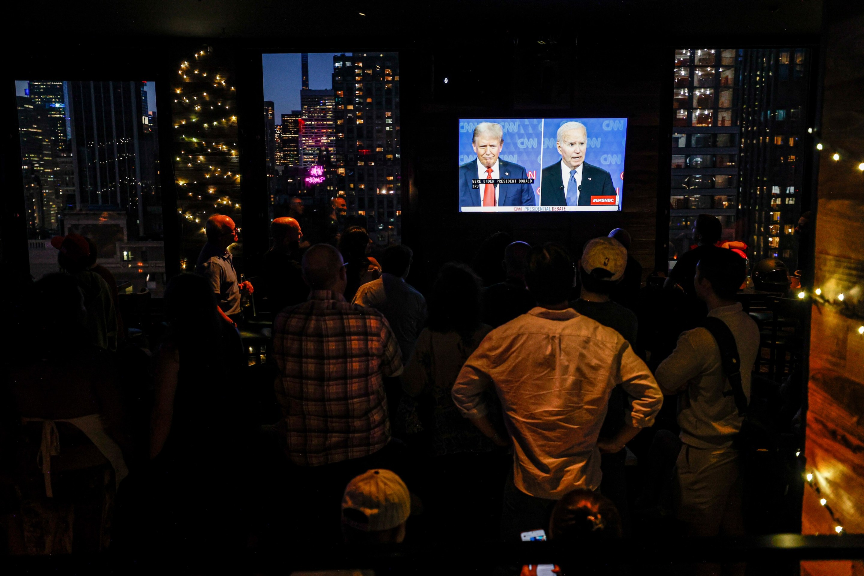 New Yorkers watch the 2024 Presidential Debate between Trump and Biden in New York City, United States on June 27, 2024.