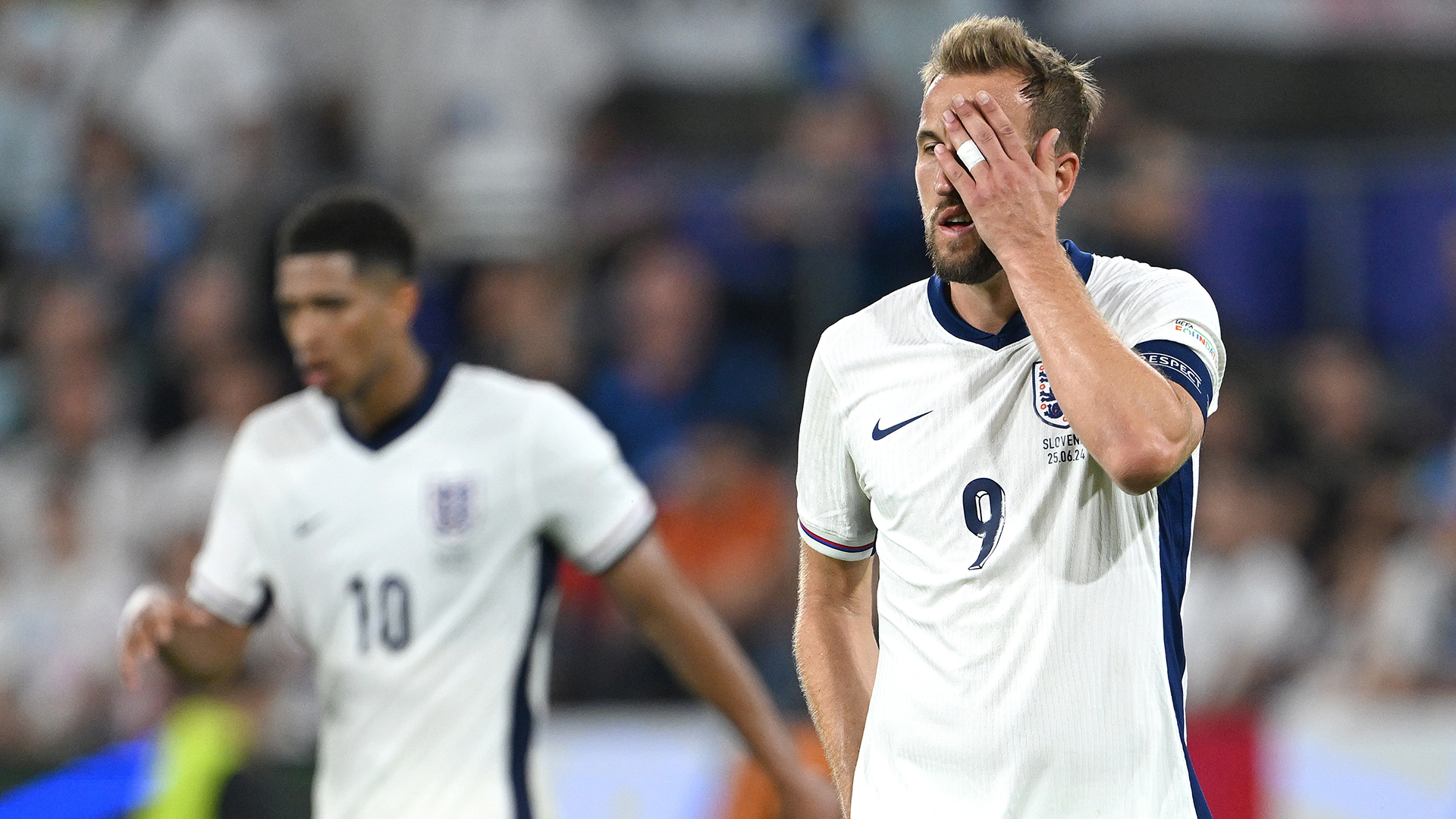 England captain harry Kane reacts after a near miss as Jude Bellingham of England looks on during the UEFA EURO 2024 group stage match between England and Slovenia at Cologne Stadium on June 25, 2024 in Cologne, Germany.