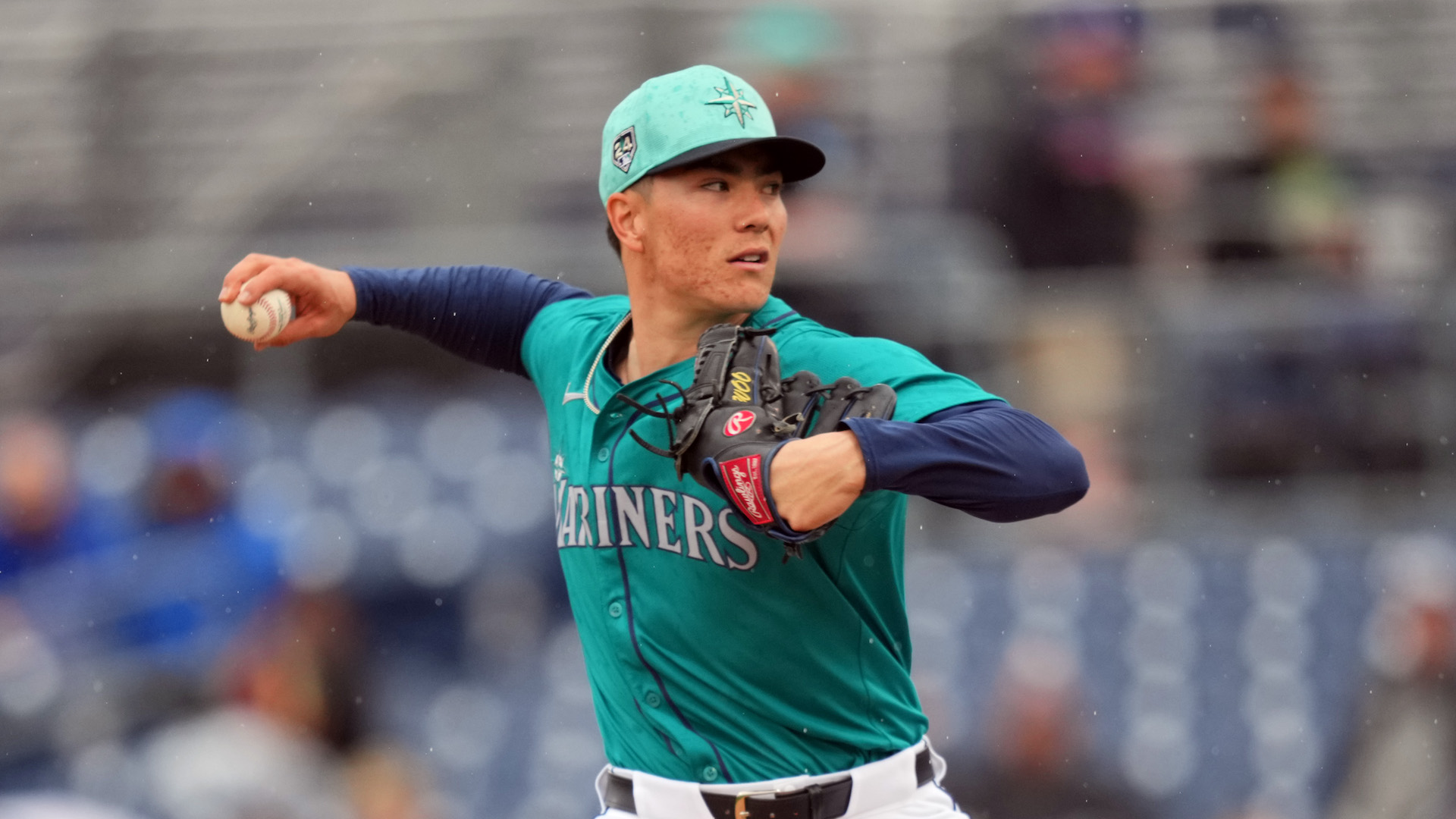 Bryan Woo #22 of the Seattle Mariners throws in the first inning during a spring training game against the Los Angeles Angels.
