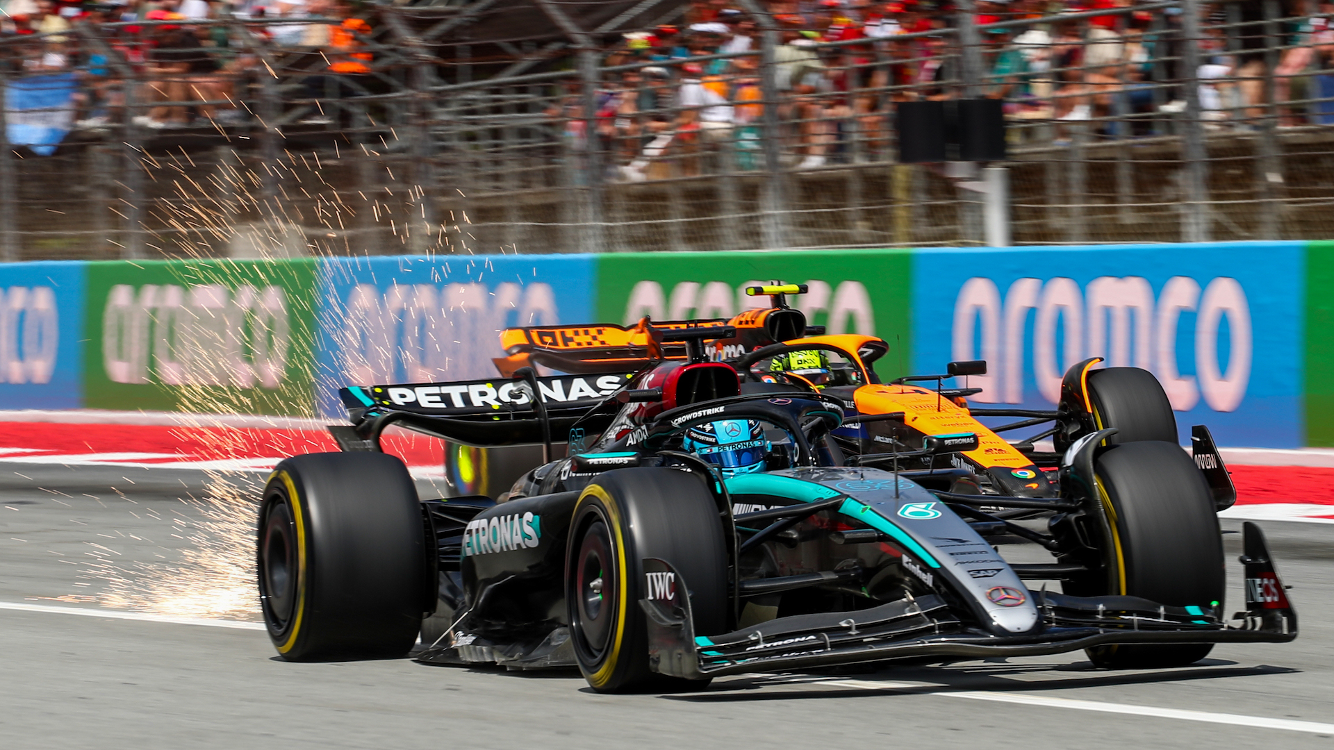 George Russell of Mercedes defends against Lando Norris of McLaren during the F1 Grand Prix of Spain.