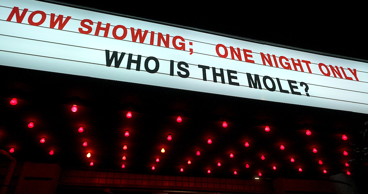 Theater marquee asking "Who is the Mole?"