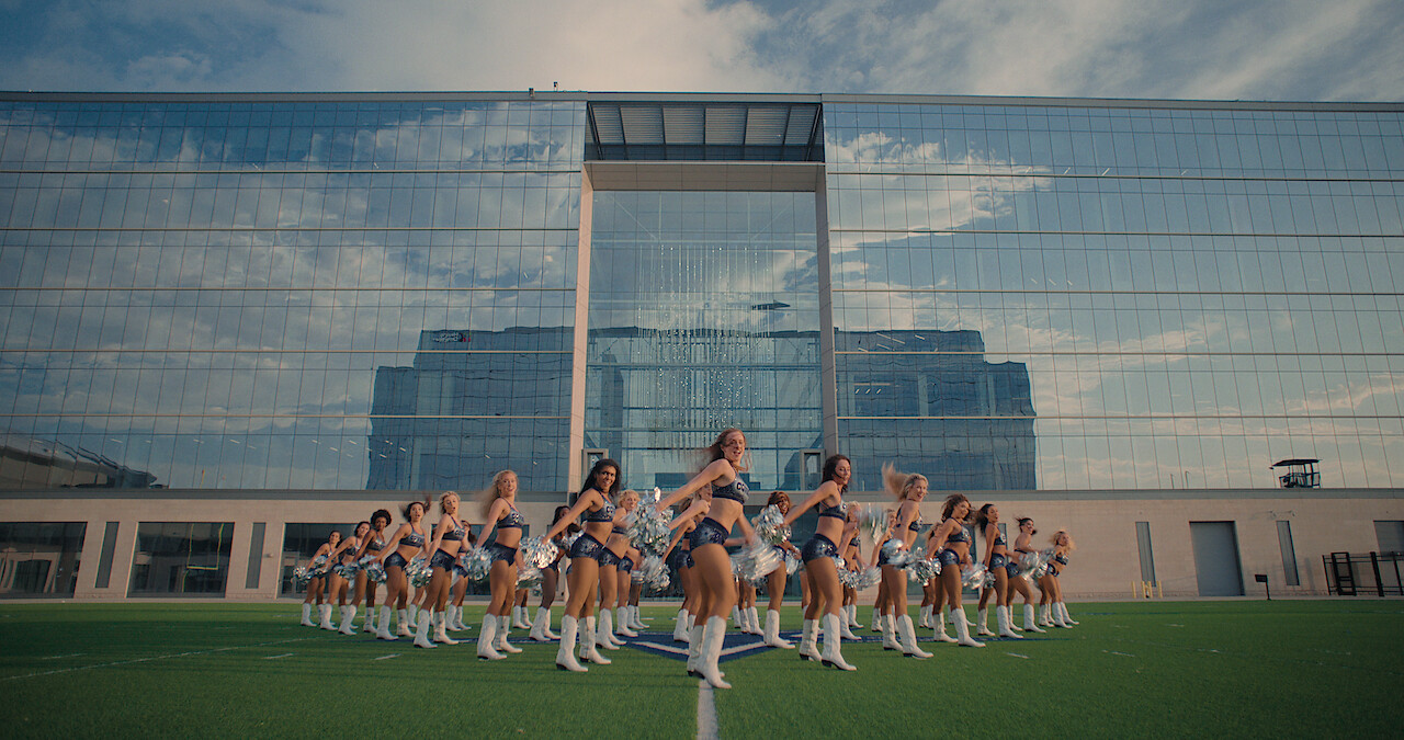 a group of Dallas Cowboys Cheerleaders practice outside