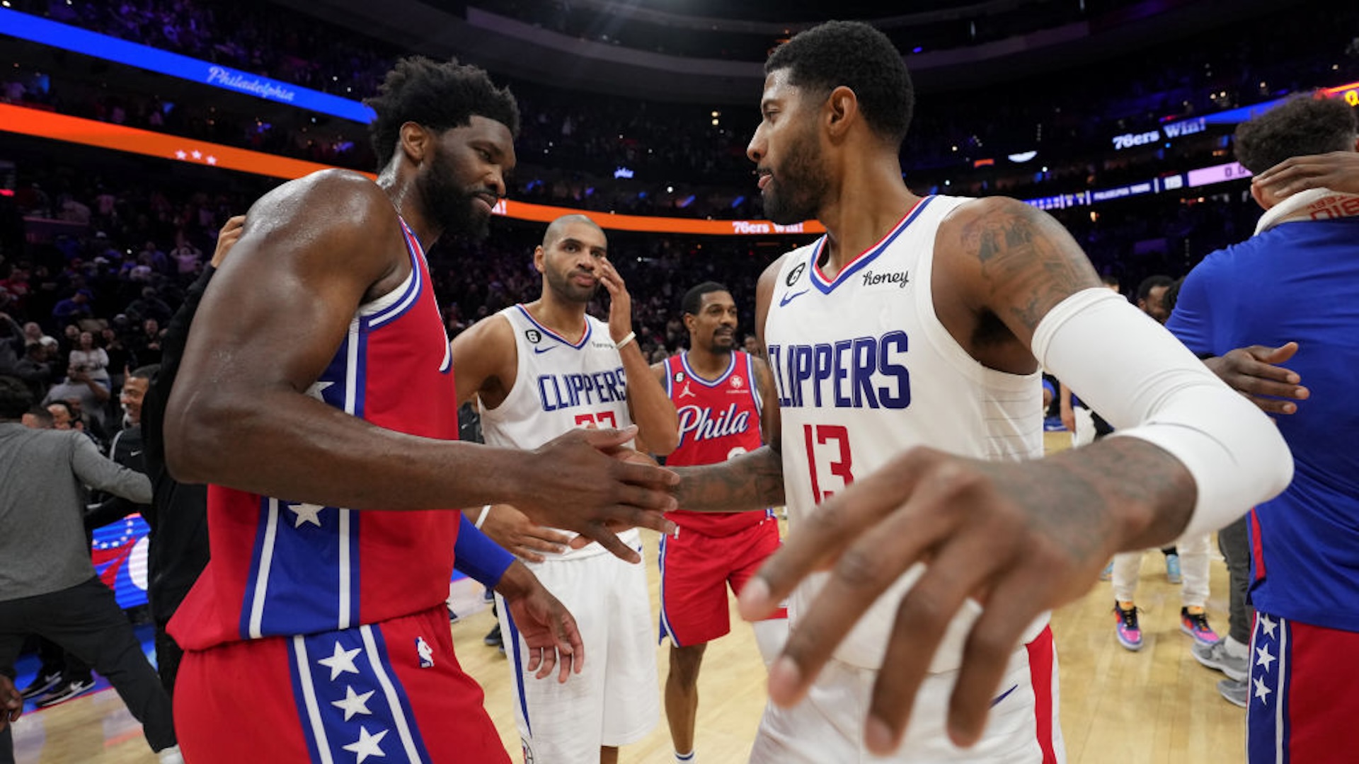 Joel Embiid #21 of the Philadelphia 76ers high fives Paul George #13 of the LA Clippers after the game on December 23, 2022 at the Wells Fargo Center in Philadelphia, Pennsylvania