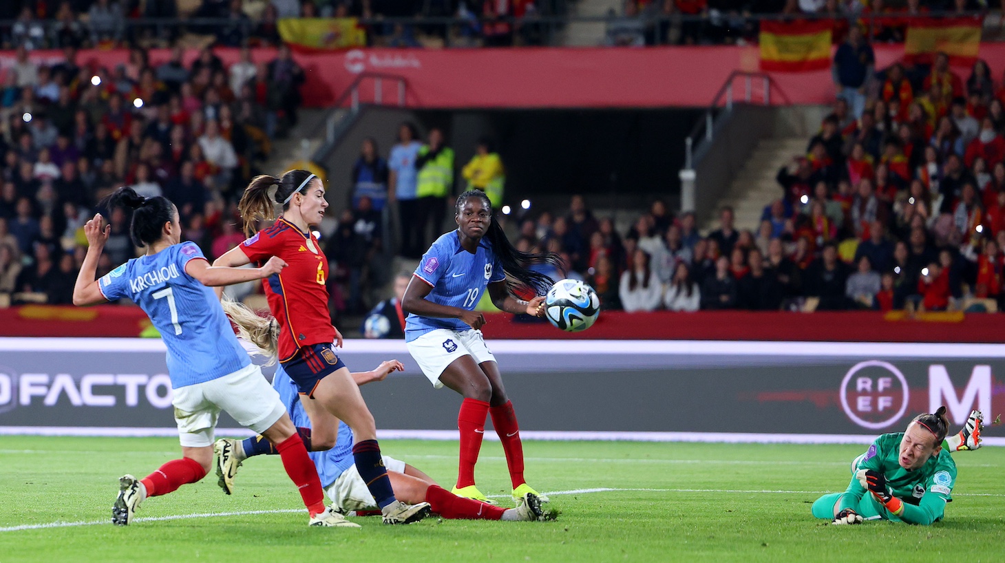 Aitana Bonmati of Spain scores her team's first goal whilst under pressure from Sakina Karchaoui and Amandine Henry of France as Pauline Peyraud-Magnin looks on during the UEFA Women's Nations League 2024 Final match between Spain and France at Estadio La Cartuja on February 28, 2024 in Seville, Spain.