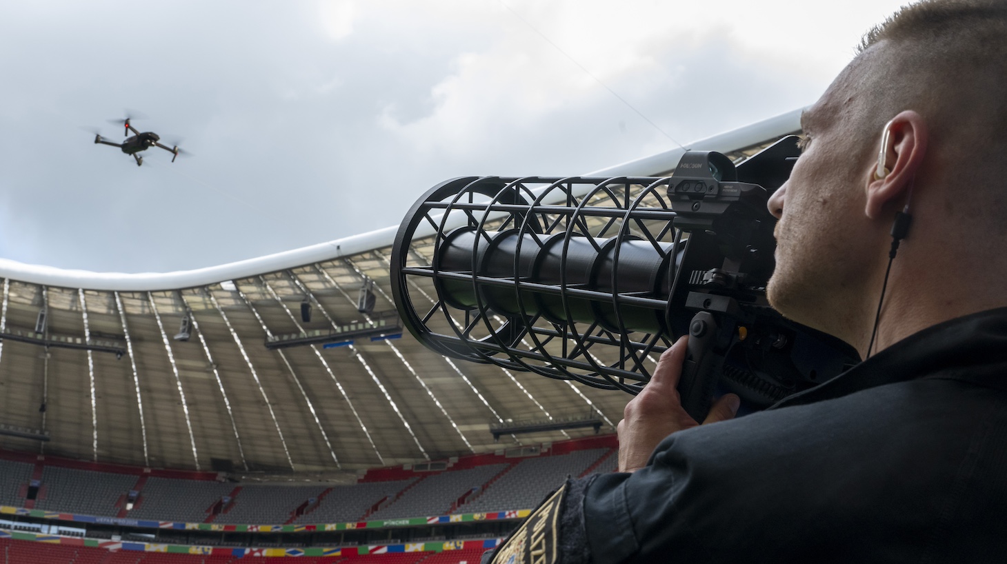 A specially trained police officer demonstrates a controlled landing of a drone using a drone jammer during the presentation of the Munich security concept for the 2024 European Football Championship at the Munich soccer stadium.