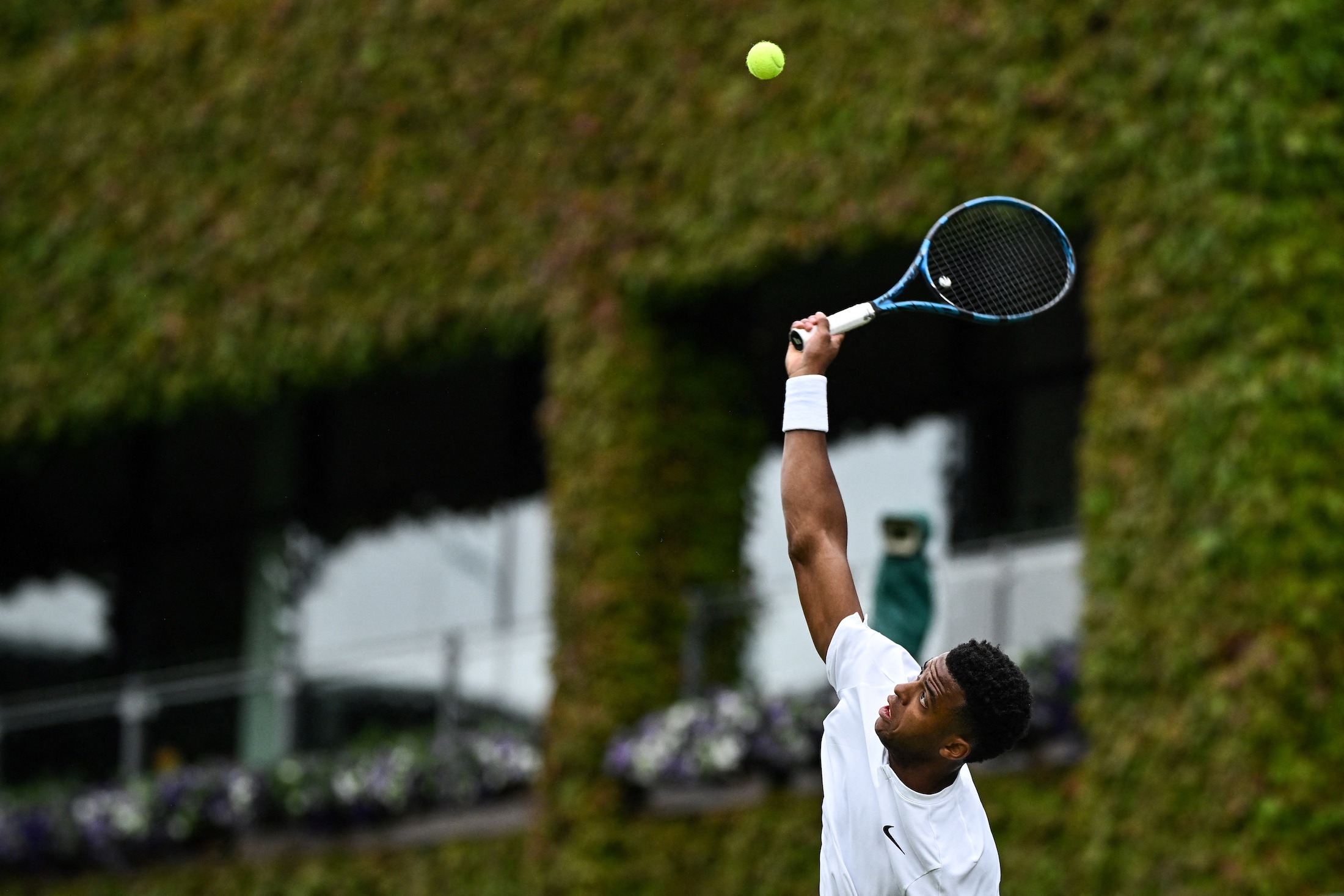 France's Giovanni Mpetshi Perricard serves the ball to USA's Sebastian Korda during their men's singles tennis match on the second day of the 2024 Wimbledon Championships at The All England Lawn Tennis and Croquet Club in Wimbledon, southwest London, on July 2, 2024.