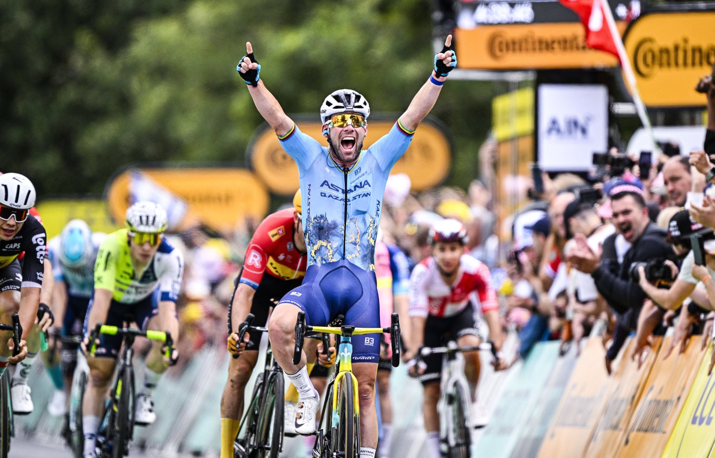 Mark Cavendish of Astana Qazaqstan celebrates as he crosses the finish line to win the stage 5 of the 2024 Tour de France.