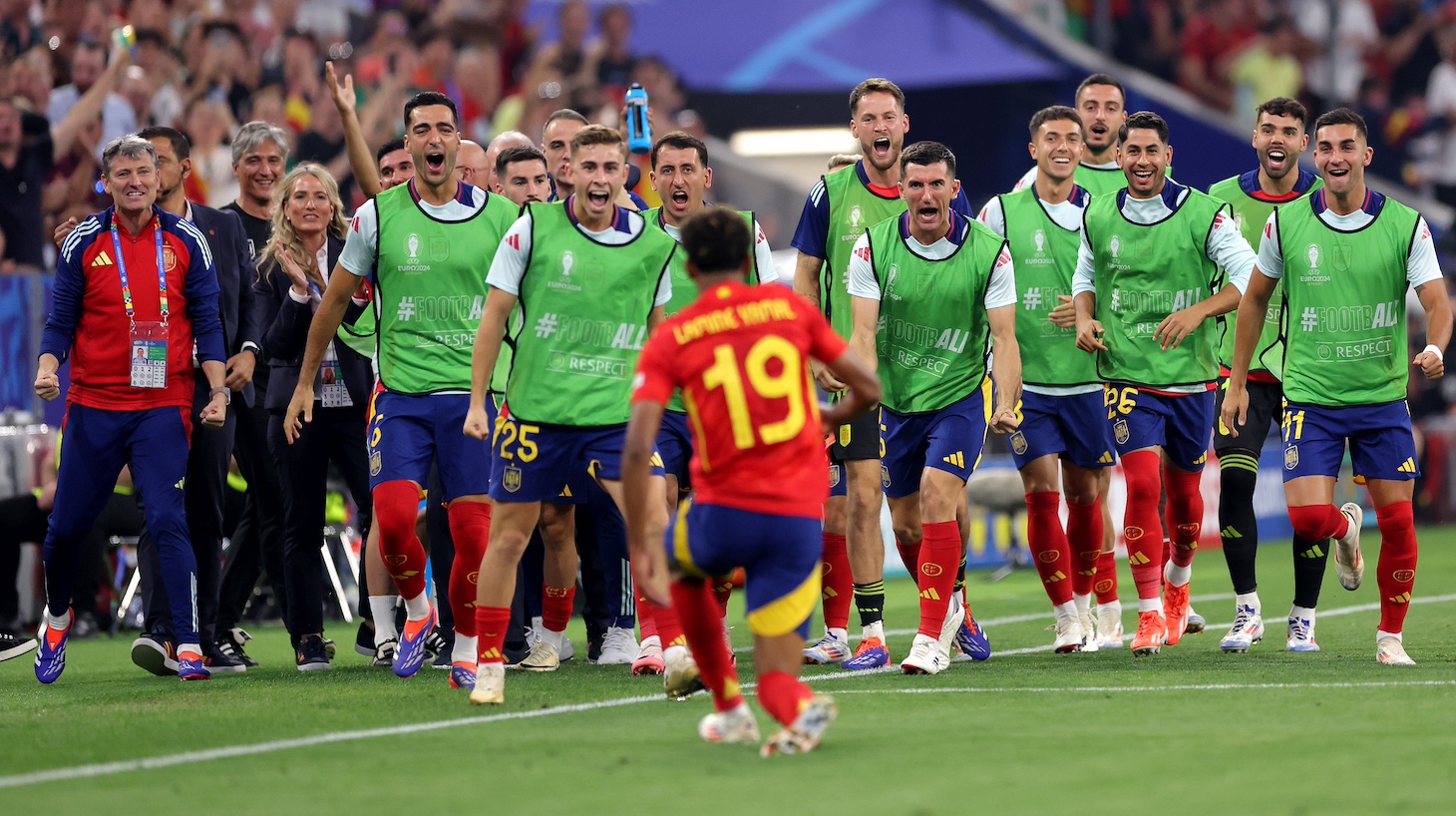 Players of Spain celebrate on the bench as Lamine Yamal of Spain celebrates scoring his team's first goal during the UEFA EURO 2024 Semi-Final match between Spain and France at Munich Football Arena on July 09, 2024 in Munich, Germany.