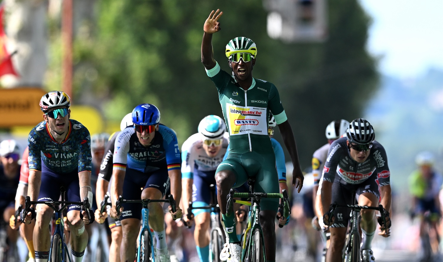 VILLENEUVE-SUR-LOT, FRANCE - JULY 11: (EDITOR'S NOTE: Alternate crop) Biniam Girmay of Eritrea and Team Intermarche - Wanty - Green Sprint Jersey celebrates at finish line as stage winner ahead of (L-R) Wout Van Aert of Belgium and Team Visma | Lease a Bike, Pascal Ackermann of Germany and Team Israel - Premier Tech and Jasper Philipsen of Belgium and Team Alpecin - Deceuninck during the 111th Tour de France 2024, Stage 12 a 203.6km stage from Aurillac to Villeneuve-sur-Lot / #UCIWT / on July 11, 2024 in Villeneuve-sur-Lot, France. (Photo by Tim de Waele/Getty Images)