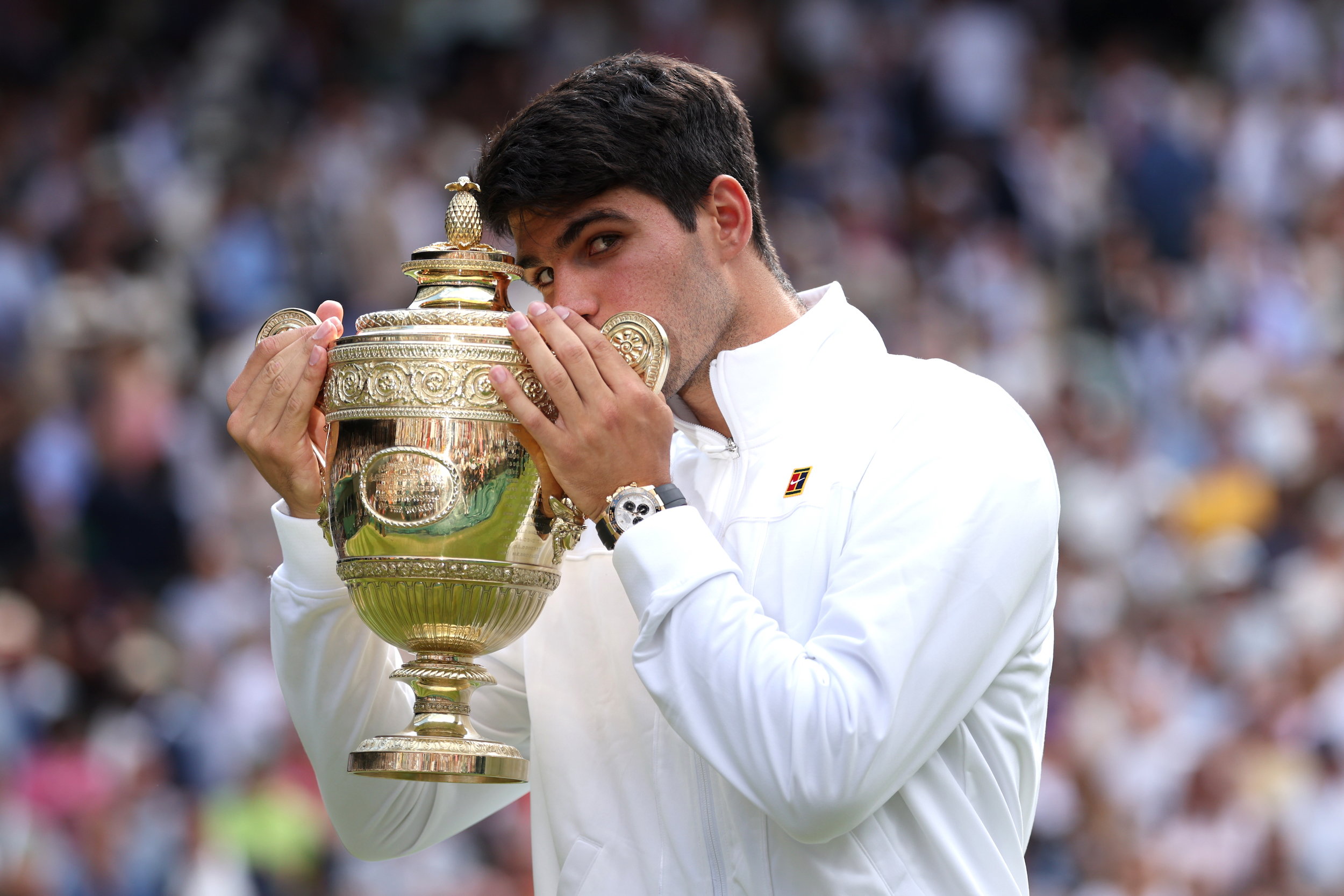 Carlos Alcaraz of Spain kisses the Gentlemen's Singles Trophy following victory against Novak Djokovic of Serbia in the Gentlemen's Singles Final during day fourteen of The Championships Wimbledon 2024 at All England Lawn Tennis and Croquet Club on July 14, 2024 in London, England. (Photo by Clive Brunskill/Getty Images)