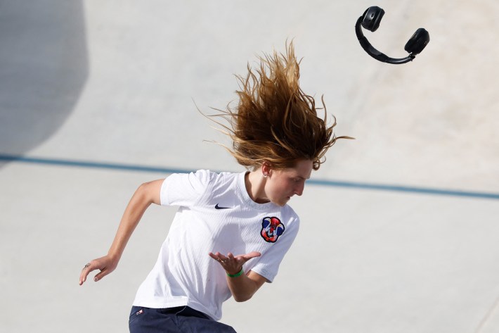 The headphones of US' Poe Pinson fall as she competes in the women's street skateboarding final during the Paris 2024 Olympic Games at La Concorde in Paris on July 28, 2024.