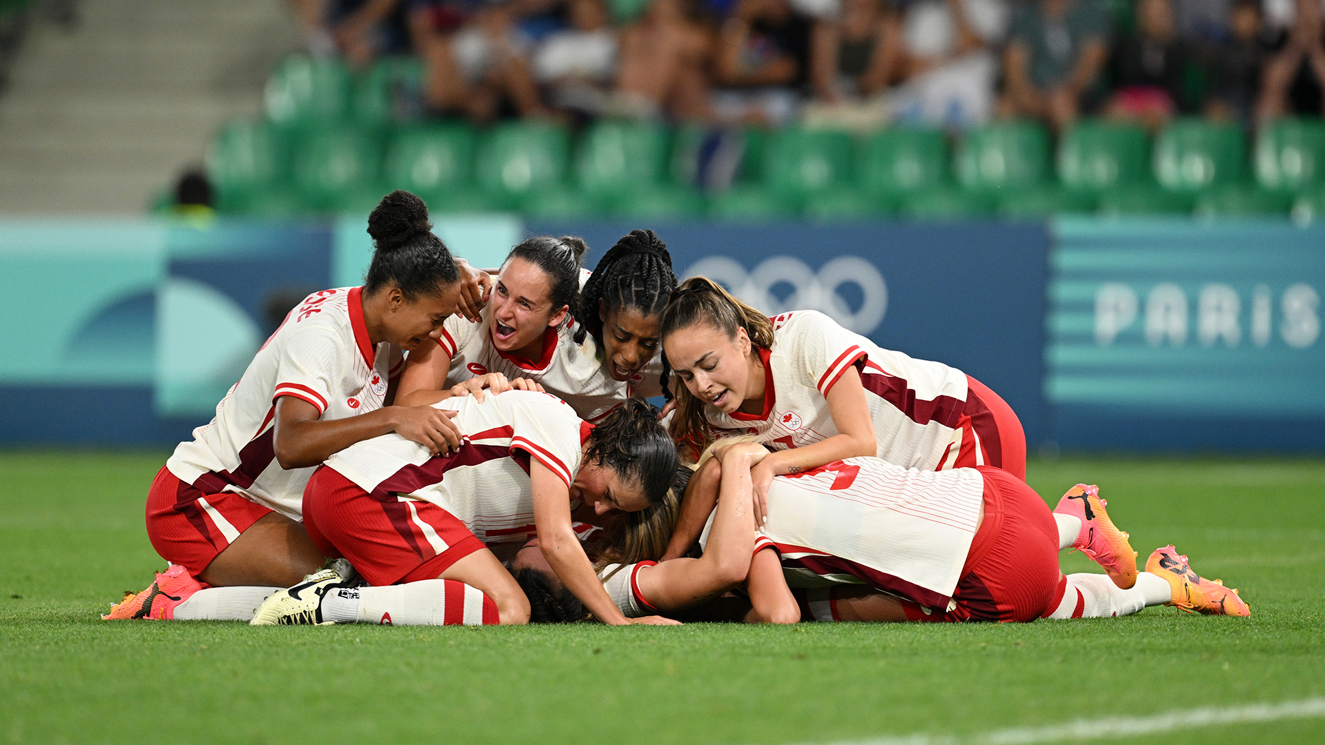 Vanessa Gilles #14 of Team Canada celebrates with teammates after scoring her team's second goal during the Women's group A match between France and Canada during the Olympic Games Paris 2024 at Stade Geoffroy-Guichard on July 28, 2024 in Saint-Etienne, France.