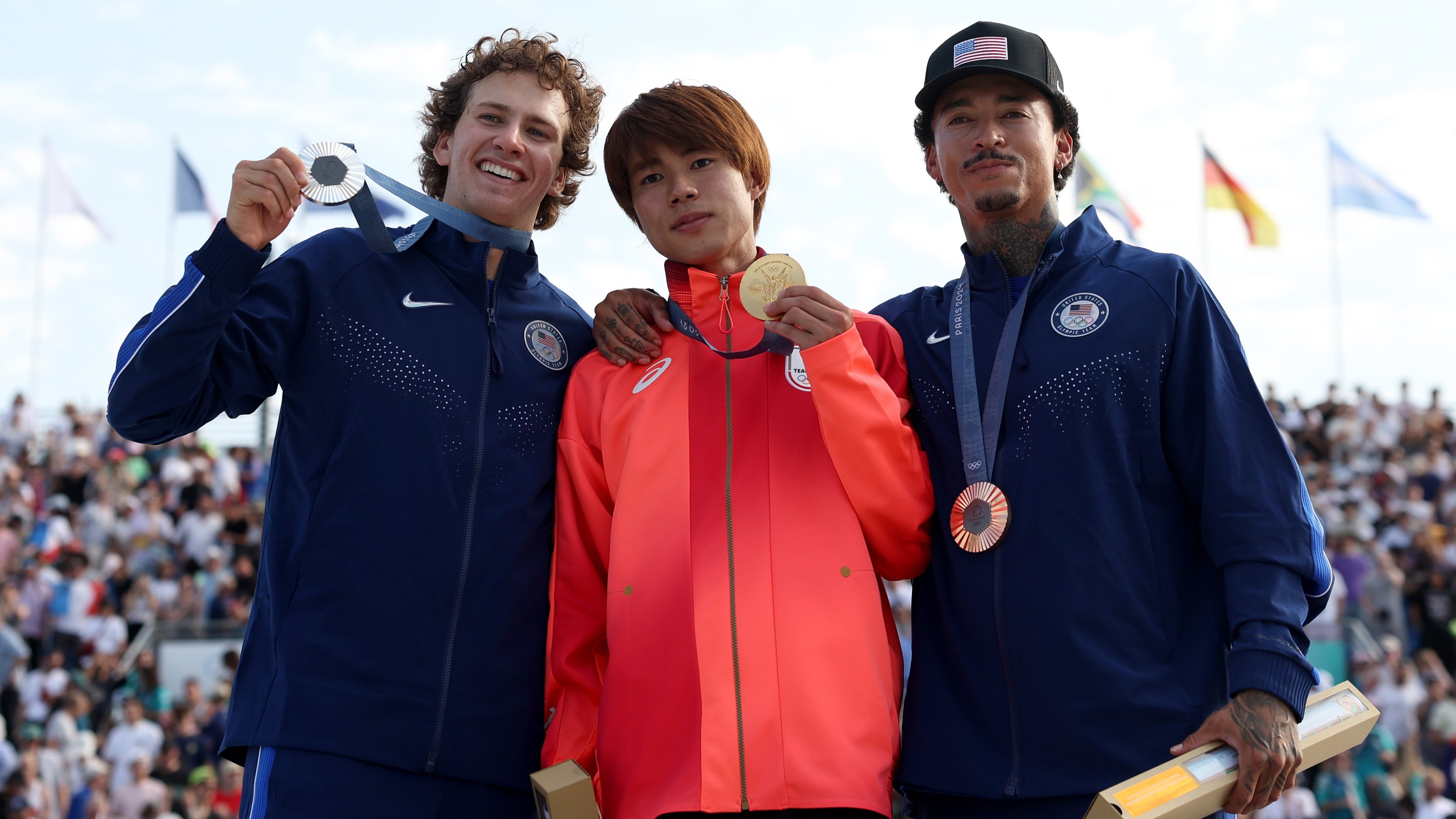 Gold medalist Yuto Horigome of Team Japan (C), Silver medalist Jagger Eaton of Team United States (L) and Bronze medalist Nyjah Huston of Team United States (R) pose on the podium uring the Men's Street Finals on day three of the Olympic Games Paris 2024 at Place de la Concorde on July 29, 2024 in Paris, France.