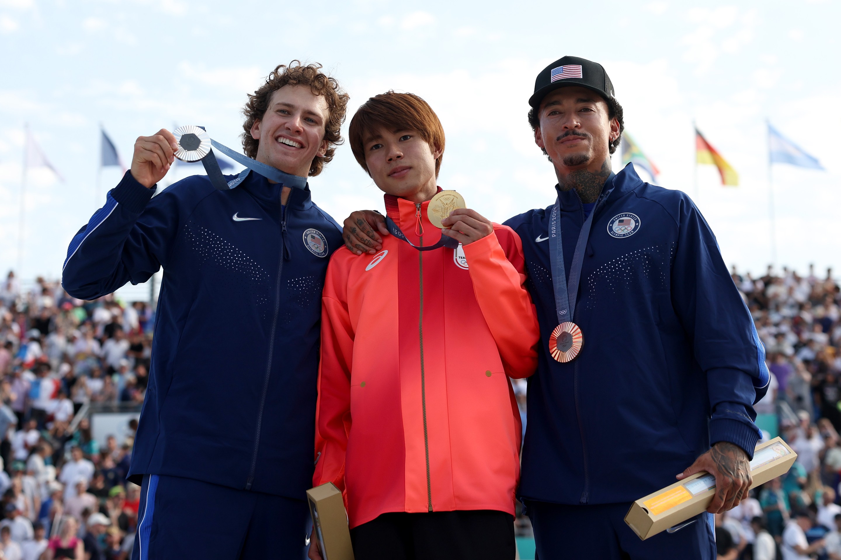 Gold medalist Yuto Horigome of Team Japan (C), Silver medalist Jagger Eaton of Team United States (L) and Bronze medalist Nyjah Huston of Team United States (R) pose on the podium uring the Men's Street Finals on day three of the Olympic Games Paris 2024 at Place de la Concorde on July 29, 2024 in Paris, France.