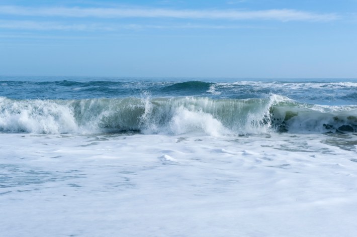 Waves crash at the beach.