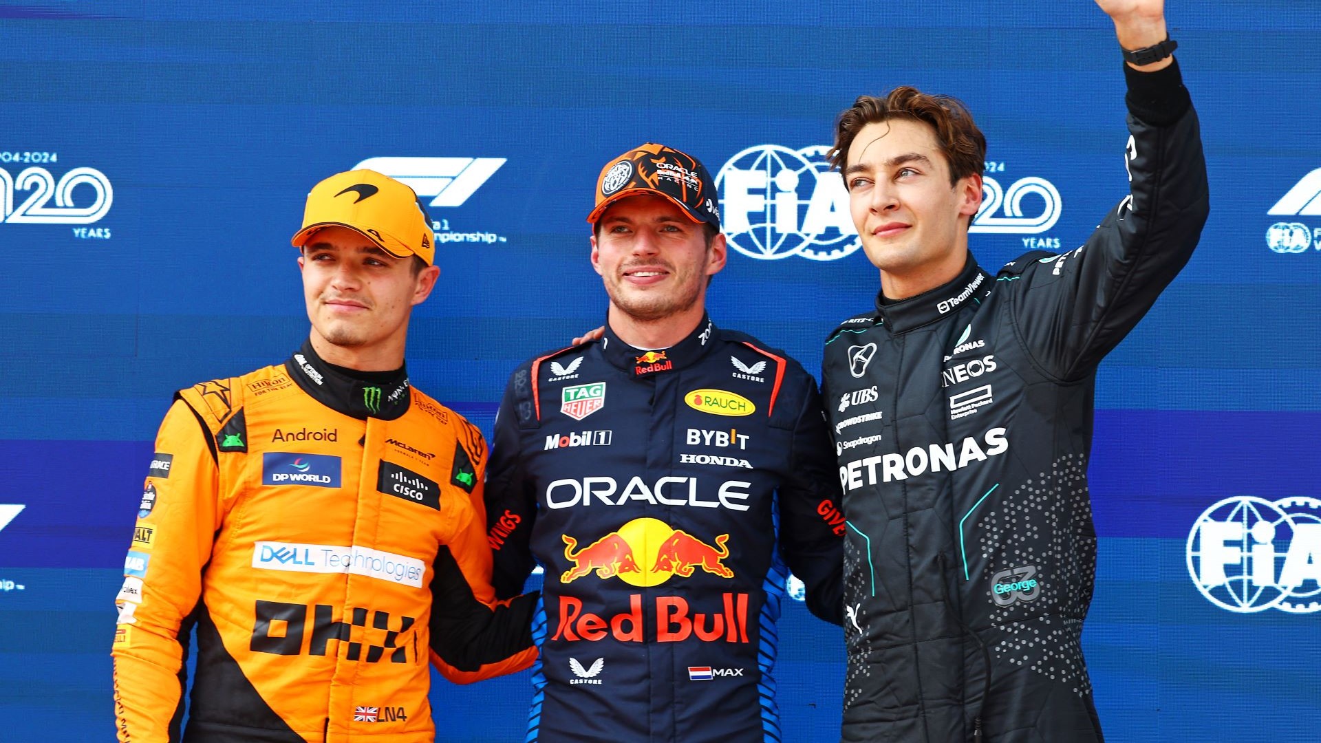 Pole position qualifier Max Verstappen of the Netherlands and Oracle Red Bull Racing, Second placed qualifier Lando Norris of Great Britain and McLaren and Third placed George Russell of Great Britain and Mercedes pose for a photo in parc ferme during qualifying ahead of the F1 Grand Prix of Austria.