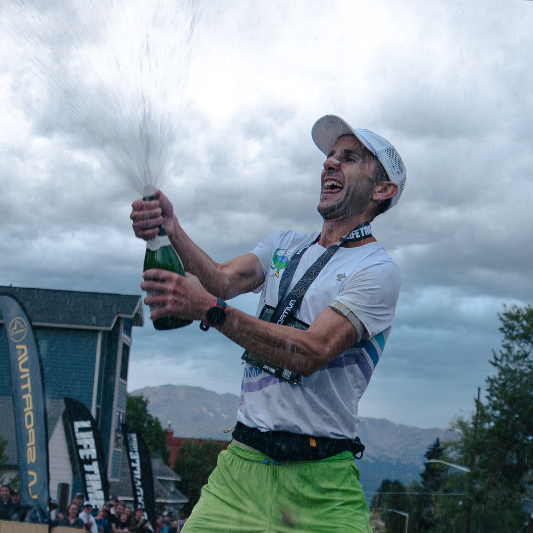David Roche sprays a bottle of champagne after winning the Leadville 100