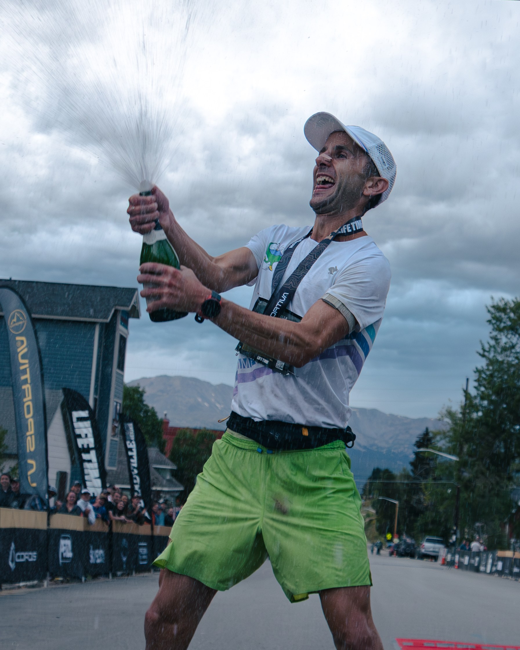 David Roche sprays a bottle of champagne after winning the Leadville 100