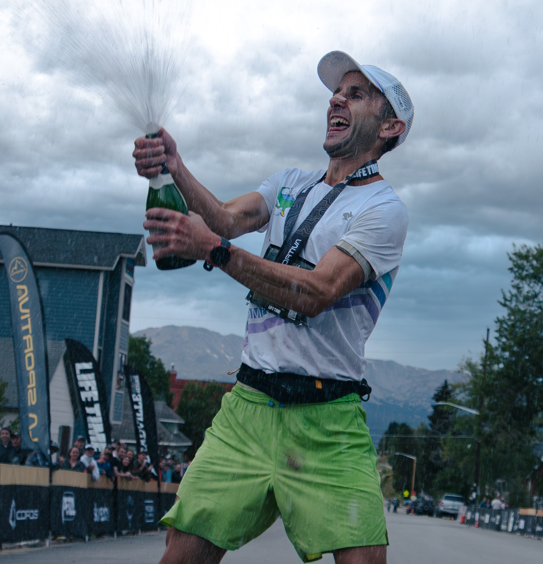 David Roche sprays a bottle of champagne after winning the Leadville 100